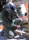 Hammering down.MUSCATATUCK URBAN TRAINING CENTER, Ind. — A Marine assigned to the Chemical, Biological Incident Response Force uses a hammers wooden bracing together to support a collapsing building during a Vibrant Response 13 field training exercise at the Muscatatuck Urban Training Center, Ind., July 29. The CBIRF unit was responsible for decontaminating, treating and evacuating displaced civilians in the collapsed building. During the simulated training exercise, the rescue technicians used high-powered tools and equipment to maneuver through the four levels of the infrastructure so they could safely evacuate civilians during the training venue.  (U.S. Army photo by Sgt. Terence Ewings, Army North PAO)