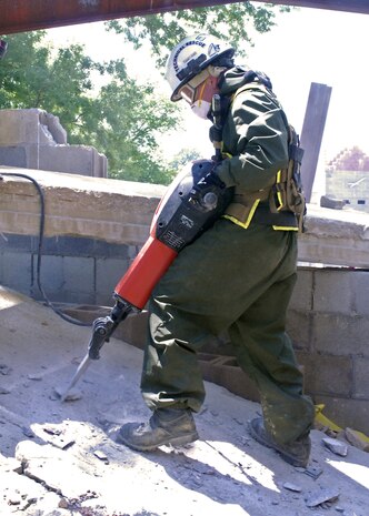 Jackhammering.MUSCATATUCK URBAN TRAINING CENTER, Ind. — A Marine assigned to the Chemical, Biological Incident Response Force uses a motorized jackhammer to break through a slab of concrete during a search and extraction operation, which is part of the Vibrant Response 13 field training exercise at the Muscatatuck Urban Training Center, Ind., July 29.  The CBRIF unit used high-powered tools and equipment to maneuver through four levels of a collapsing building and evacuate civilians during the training venue.  (U.S. Army photo by Sgt. Terence Ewings, Army North PAO)