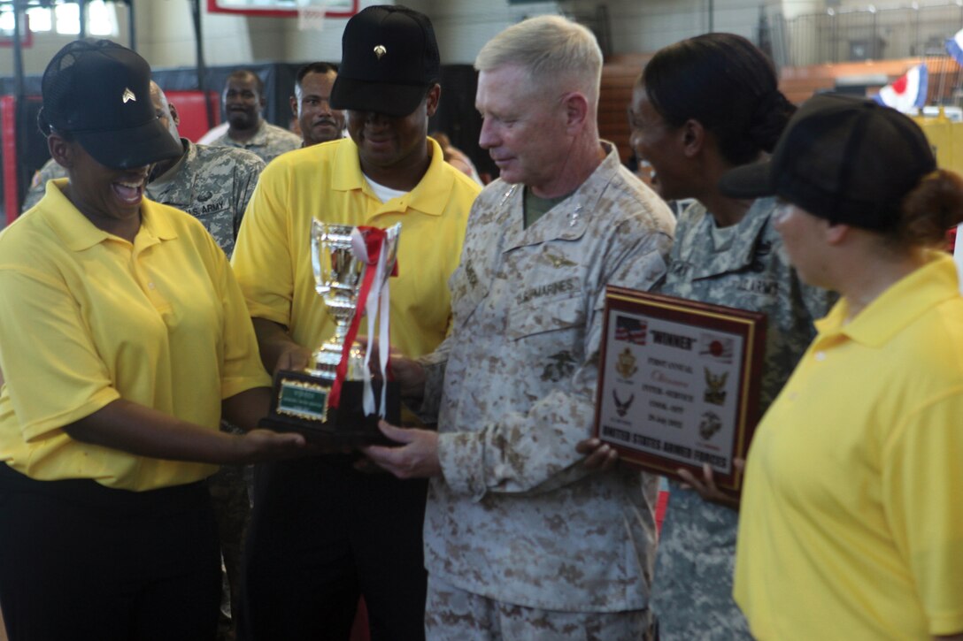 Lt. Gen. Kenneth J. Glueck Jr. stands with the Army culinary team as it receives the first-place trophy for the first annual interservice cook-off July 28. Glueck is the commanding general of III Marine Expeditionary Force. 