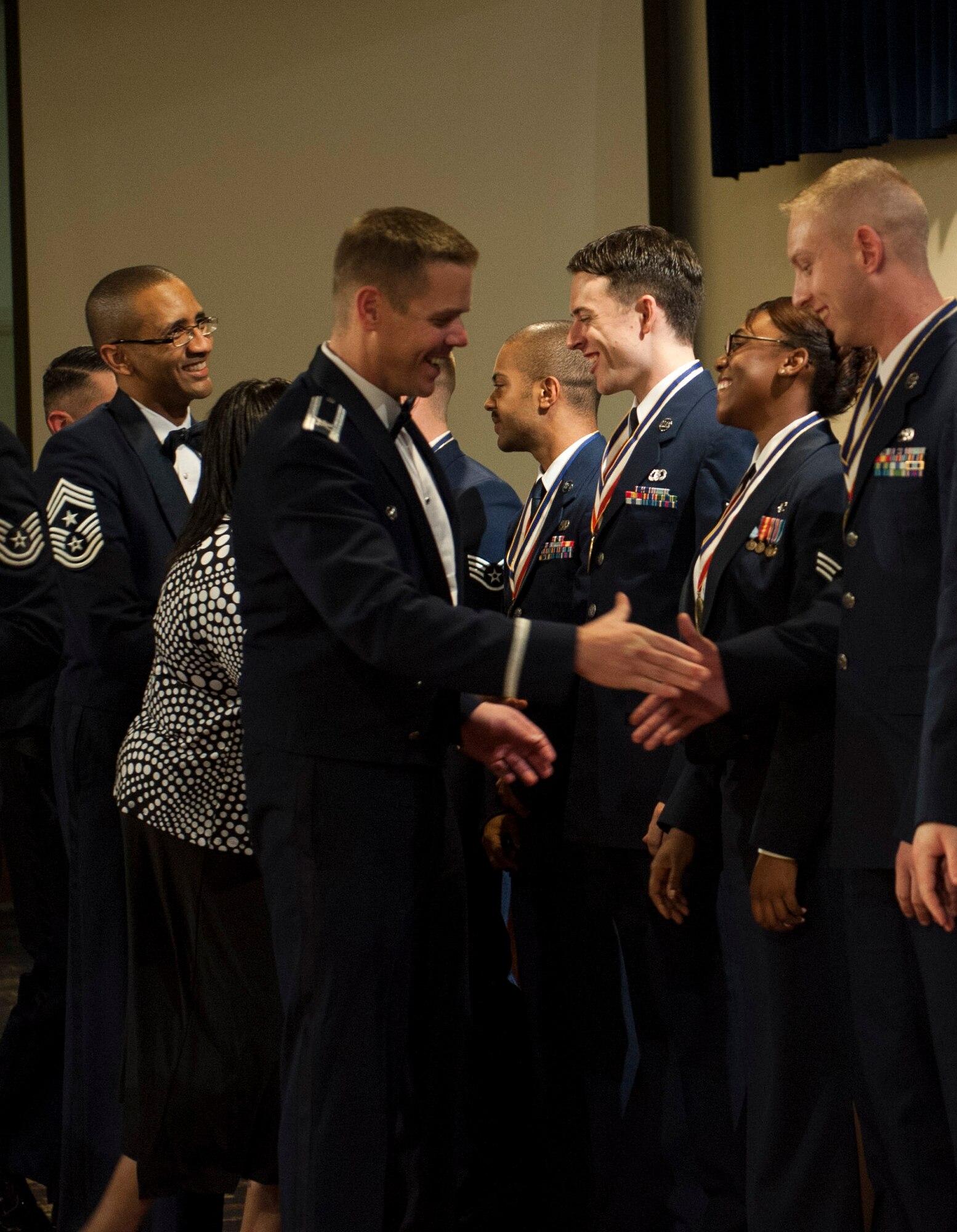 YOKOTA AIR BASE, Japan -- Col. Charles Brown, 374th Airlift Wing vice wing commander, center, and Chief Master Sgt. Ronald Draper, 374th AW command chief master sergeant, left, congratulates graduates from Airman Leadership School Class 12- at the Yokota Enlisted Club, Yokota Air Base, Japan, Aug. 9, 2012. (U.S. Air Force photo by Senior Airman Andrea Salazar)