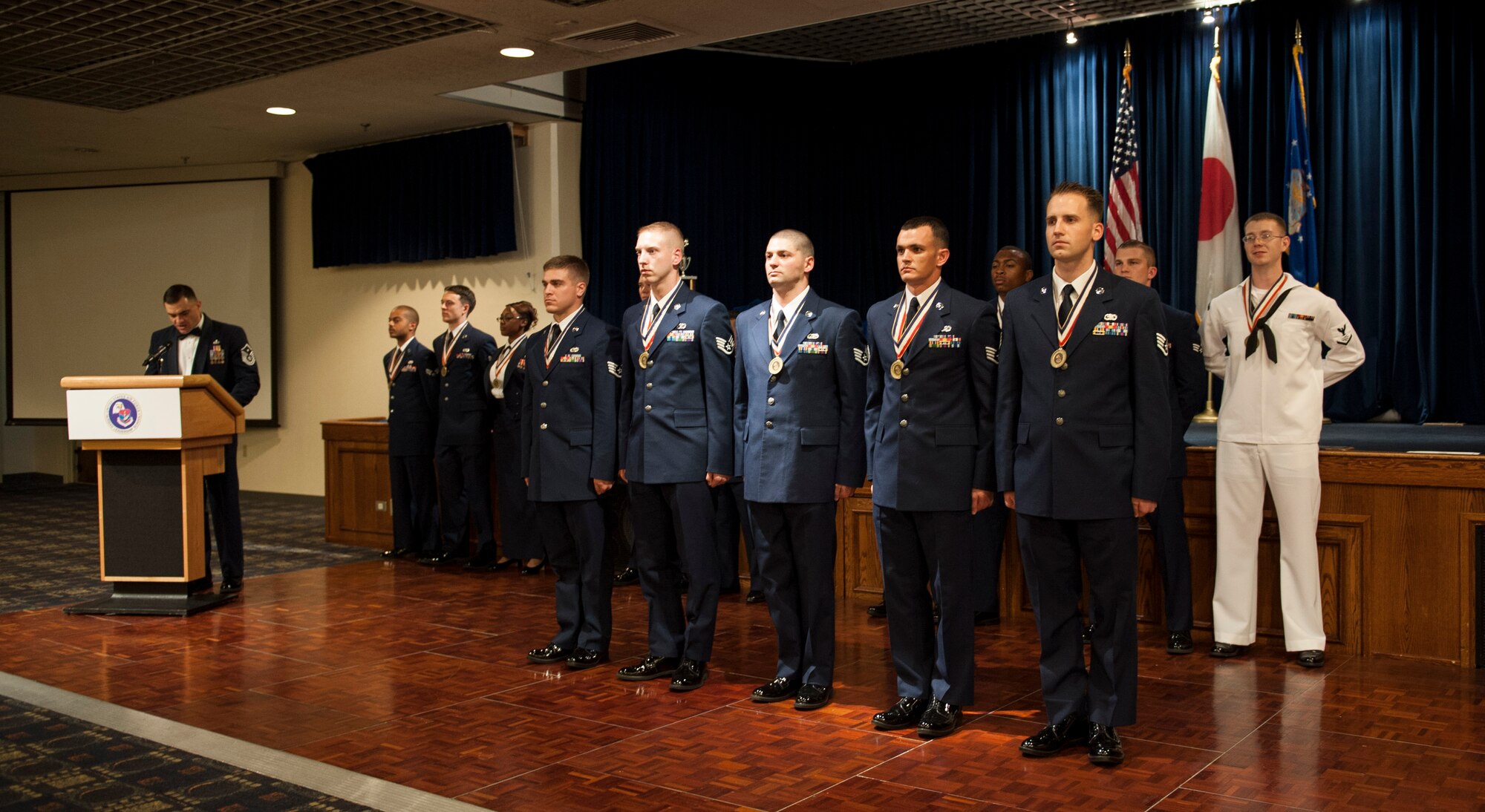 YOKOTA AIR BASE, Japan -- Staff sergeants graduating from Airman Leadership School Class 12-F accept the NCO charge at the end of their graduation ceremony at Yokota Air Base, Japan, Aug. 9, 2012. (U.S. Air Force photo by Senior Airman Andrea Salazar)