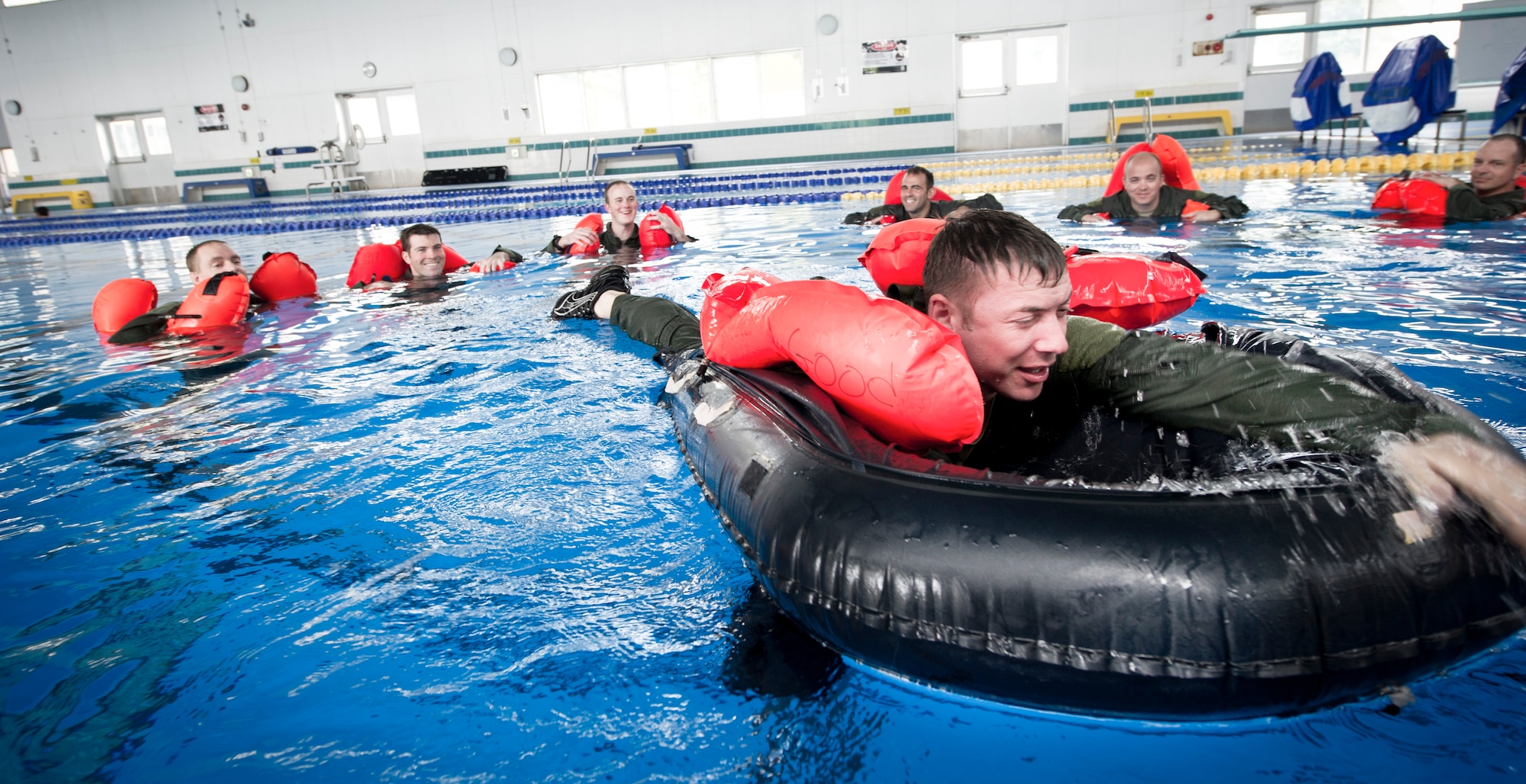 YOKOTA AIR BASE, Japan -- Capt. Curtis Geter, 36th Air Lift Squadron pulls himself into a one man life raft during survival, evasion, resistance and escape training, July 24, 2012 at Yokota Air Base, Japan.  Aircrew members learned how to survive at sea after an emergency water landing. (U.S. Air Force photo by Staff Sgt Stacy Moless)