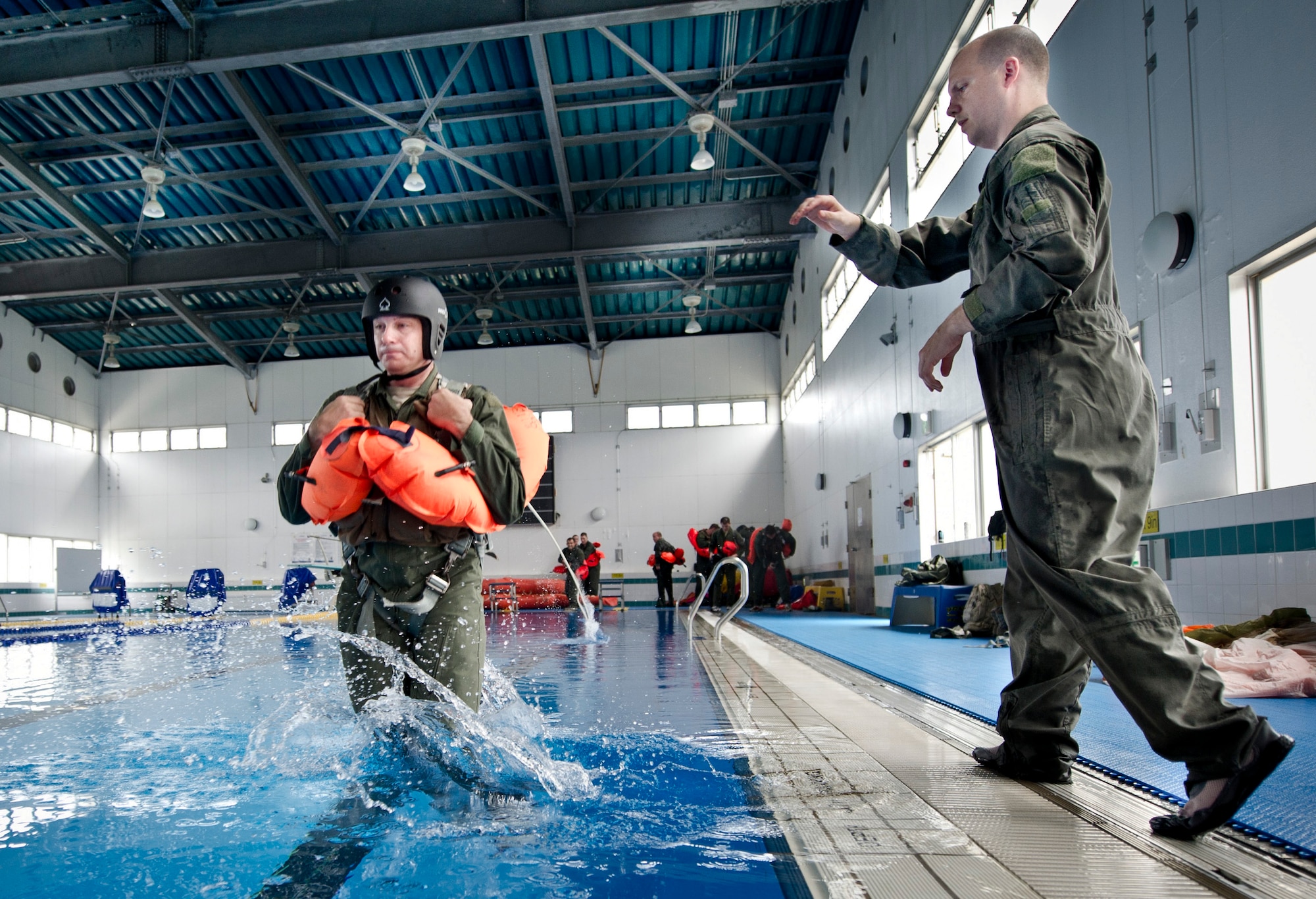 YOKOTA AIR BASE, Japan -- Tech. Sgt. Benjamin Rosciglione, 374th Operation Support Squadron survival, evasion, resistance and escape instructor, pushes Lt Col. David Nardozzi, 374th Operations Group Deputy commander, into a pool during SERE training, July 24, 2012 at Yokota Air Base, Japan.  This block of training taught water survival, giving students the tools needed to survive an emergency water landing. (U.S. Air Force photo by Staff Sgt Stacy Moless)
