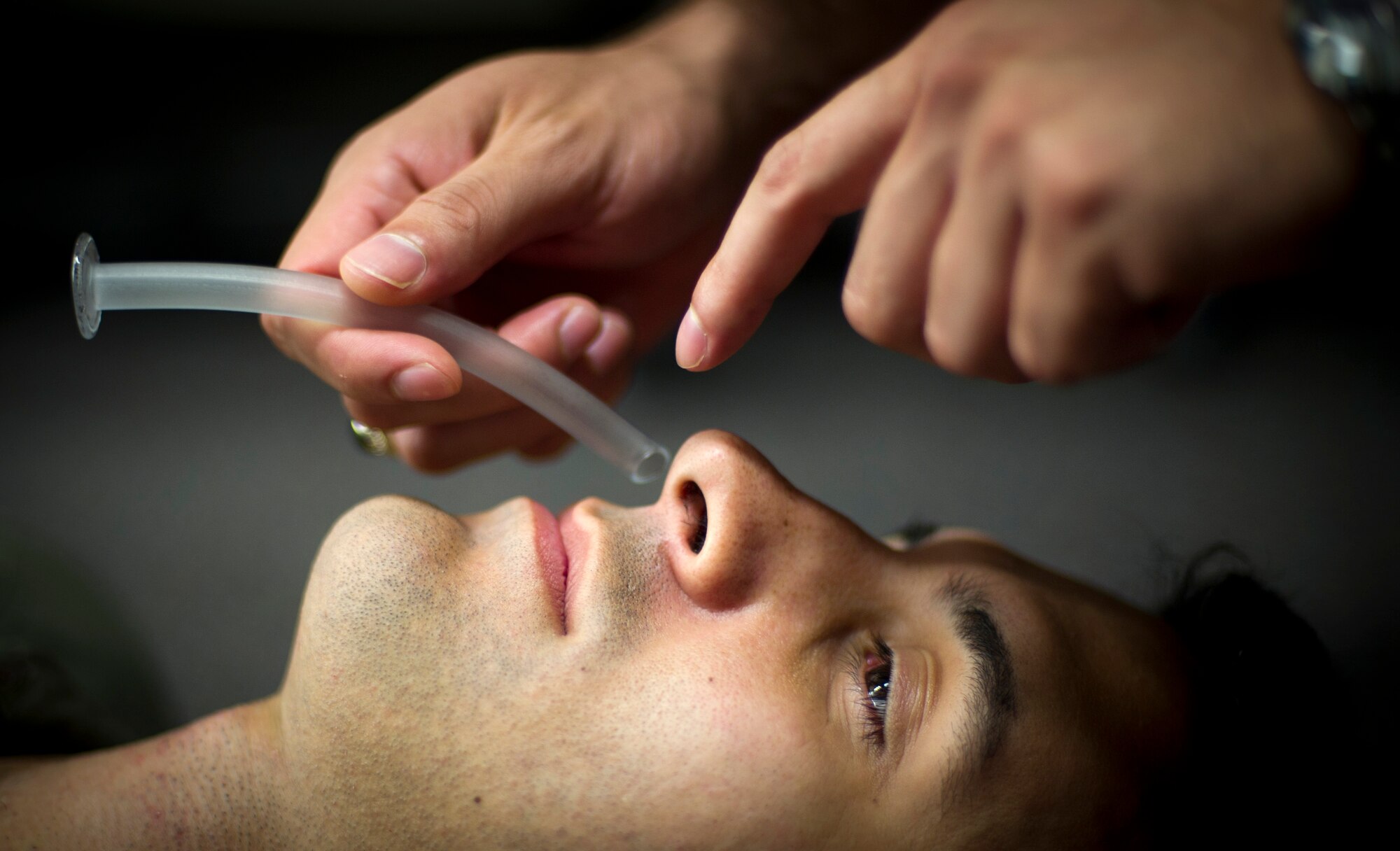 YOKOTA AIR BASE, Japan -- Capt. Nicolas Morris, 5th Air force during a simulated use of a nasopharyngeal airway during survival, evasion, resistance and escape training Aug 7, 2012 at Yokota Air base, Japan. The tube is designed to be inserted into the nasal passageway to secure an open airway in an unconscious person. (U.S. Air Force photo by Staff Sgt Stacy Moless)