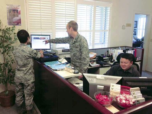 Senior Airman Shi of the 452d AMW receives guidance from Capt Matthew Mackey
and Mr. Anhtuan Dang of the Base Legal Office, on using the Legal Assistance
Kiosk available in the lobby of the Legal Office. (U.S. Air Force photo)