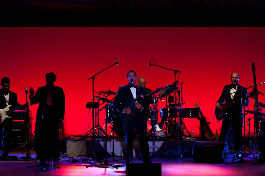 SHIOGAMA CITY, Japan -- Senior Airman William Pressgrove, Band of the Pacific-Asia vocalist, introduces the band during the beginning of Van Halen's "Right Now" as the curtain rises at the Yu Hall, Shiogama City, Miyagi Prefecture, Japan on Aug 7, 2012. "I enjoy the responsibility of introducing the band every show," stated Pressgrove. "It's a way to immediately engage and captivate the audience." (U.S. Air Force photo/Staff Sgt. Josh Voyles)