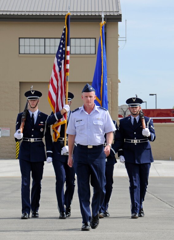 Col. Marc Van Wert, 92nd Air Refueling Wing vice commander, leads the color guard as they prepare to present the colors at Fairchild Air Force Base, Wash., Aug. 8, 2012. The change of command is a tradition that represents a formal transfer of authority and responsibility for a unit from one commander to the next. (U.S. Air Force photo by Airman 1st Class Ryan Zeski)