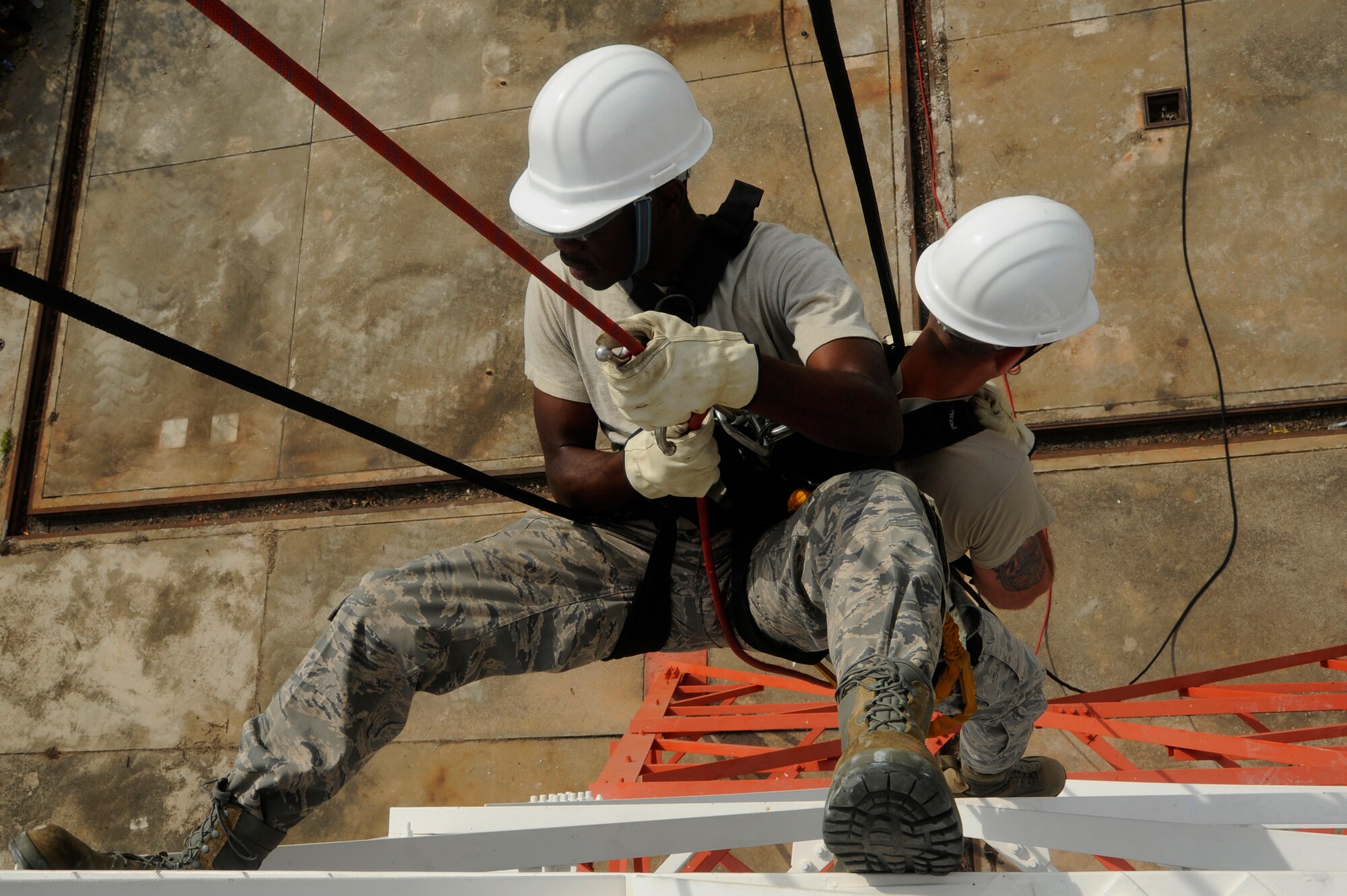 Senior Airman Lewis Holston, 8th Communications Squadron airfields systems specialist, practices rescuing Senior Airman Joshua Newell, 8th CS Airfields systems specialist, at Kunsan Air Base, Republic of Korea, Aug. 8 2012. This training is a yearly requirement of the 8 CS to ensure they maintain their skill and efficiency. (U.S. Air Force photo/Senior Airman Marcus Morris)