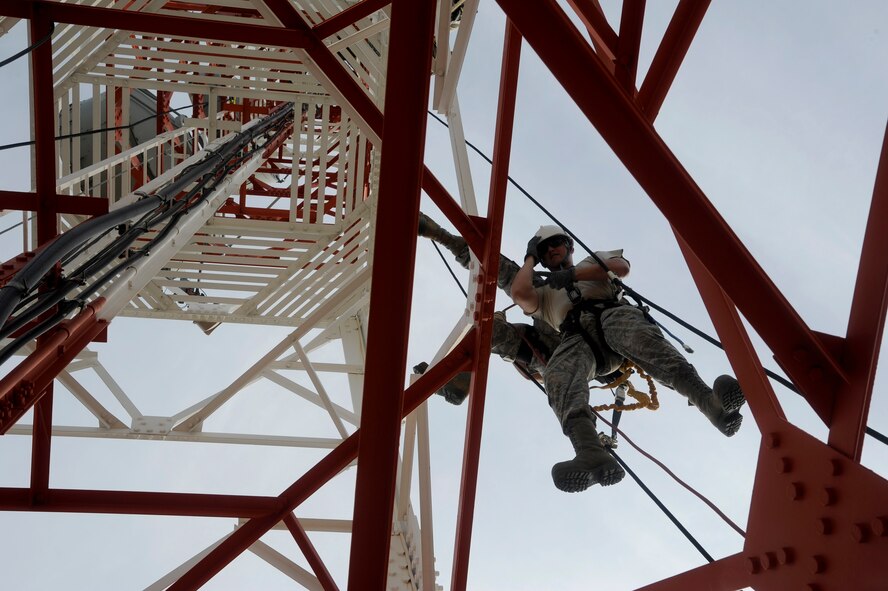 Tech. Sgt. Samuel Chytla, 8th Communications Squadron cable and antenna, practices rescuing Staff Sgt. Joel Avant, 8th CS radio frequency transmission systems, at Kunsan Air Base, Republic of Korea, Aug. 8 2012. This training is a yearly requirement of the 8th CS to ensure they maintain their skill and efficiency. (U.S. Air Force photo/Senior Airman Marcus Morris)