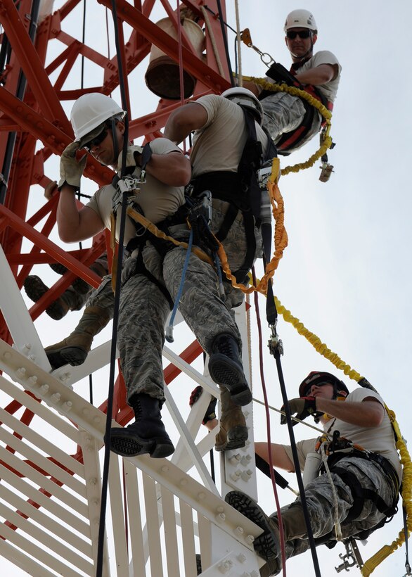 Airman 1st Class Eric Pratts, 8th Communications Squadron airfields systems specialist, practices rescuing Airman 1st Class Marc Holguin, 8th CS cable and antenna, as Tech. Sgt. Jarod Howard (top) and Staff Sgt. Edward Manning (bottom), from the 364th Training Squadron training instructors Sheppard Air Force Base, Texas, instruct them at Kunsan Air Base, Republic of Korea, Aug. 8 2012. This training is a yearly requirement of the 8th CS to ensure they maintain their skill and efficiency. (U.S. Air Force photo/Senior Airman Marcus Morris)