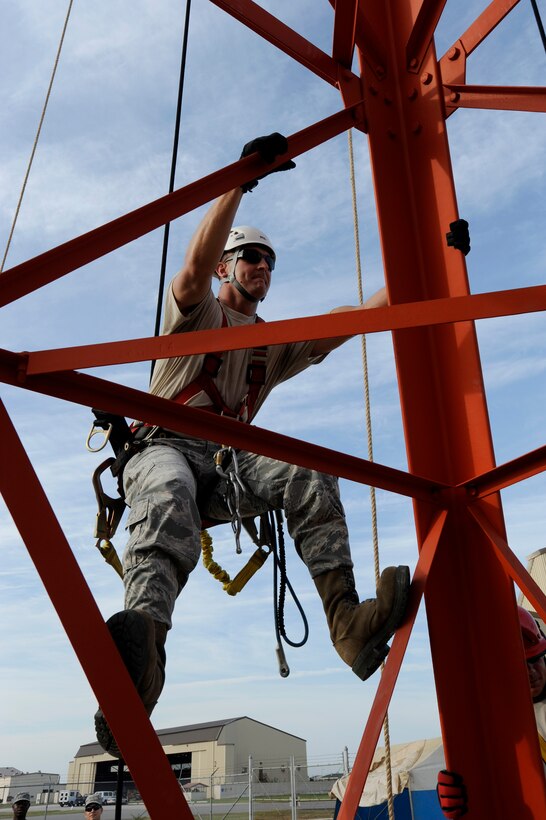 Tech. Sgt. Jarod Howard, 364th Training Squadron instructor from Sheppard Air Force Base, Texas, climbs a communication tower at Kunsan Air Base, Republic of Korea, Aug.  8, 2012. Howard is training Airmen from the 8th Communications Squadron how to rescue an injured wingman from a tower as part of their yearly training requirement. (U.S. Air Force photo/Senior Airman Marcus Morris) 