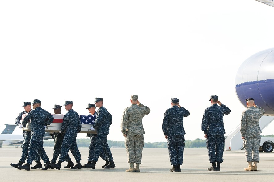 A U.S. Navy carry team transfers the remains of Navy Petty Officer 3rd Class Clayton R. Beauchamp, of Weatherford, Texas, at Dover Air Force Base, Del., Aug. 9, 2012. Beauchamp was assigned to 1st Battalion, 1st Marine Regiment, Regimental Combat Team 6, 1st Marine Division (Forward), I Marine Expeditionary Force (Forward), Camp Pendleton, Calif. (U.S. Air Force photo/Roland Balik)