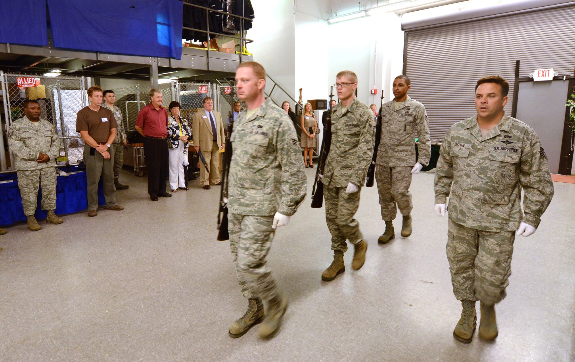 Tech. Sgt. Aaron Abshire commands Senior Airman Cameron Janzen, Airman 1st Class Shane Kilgore Jr., and Staff Sgt. Sterling Scales during an honor guard rifle team demonstration for Hercules Council members at Dobbins Air Reserve Base, Aug. 9. Members of the Hercules Council, comprised of area civic leaders, had lunch on base and visited the 94th Airlift Wing honor guard facilities to get a better understanding of what they do for the local community and region. (U.S. Air Force photo/Brad Fallin)