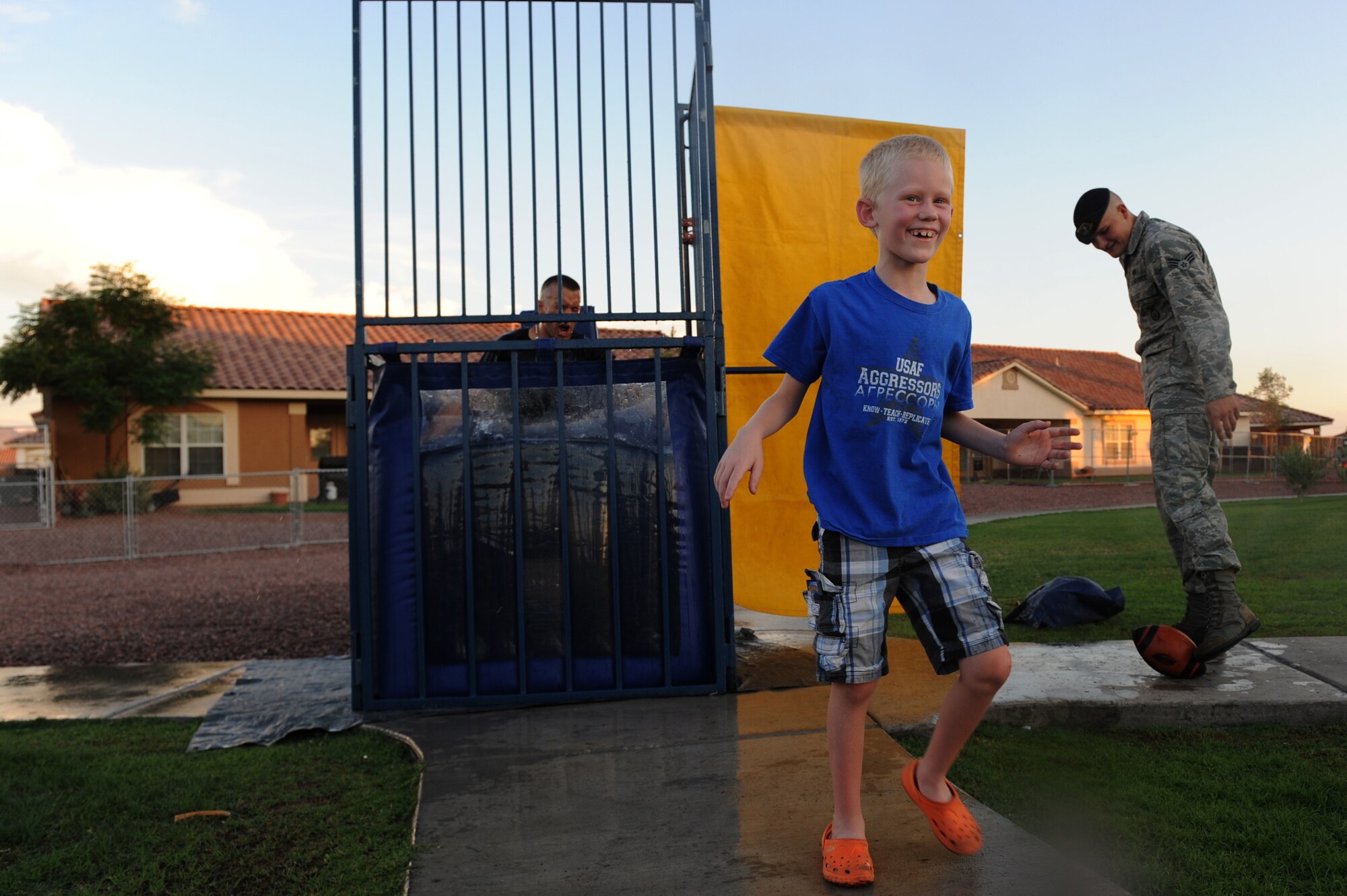 Michael Jones, son of Melissa and Jeffrey Jones, 57th Information Aggressors Squadron adversary network warfare operator, dunks 2nd U.S. Air Force Lt. Nicklaus Landon, 99th Security Forces Squadron  commanders executive, during "National Night Out" August 8, 2012, at Nellis Air Force Base, Nev. "National Night Out" is a nationwide effort to heighten crime prevention awareness, generate support for local anti-crime programs and strengthen neighborhood spirit and police-community partnerships. (U.S. Air Force photo by Staff Sgt. William P.Coleman)
  

