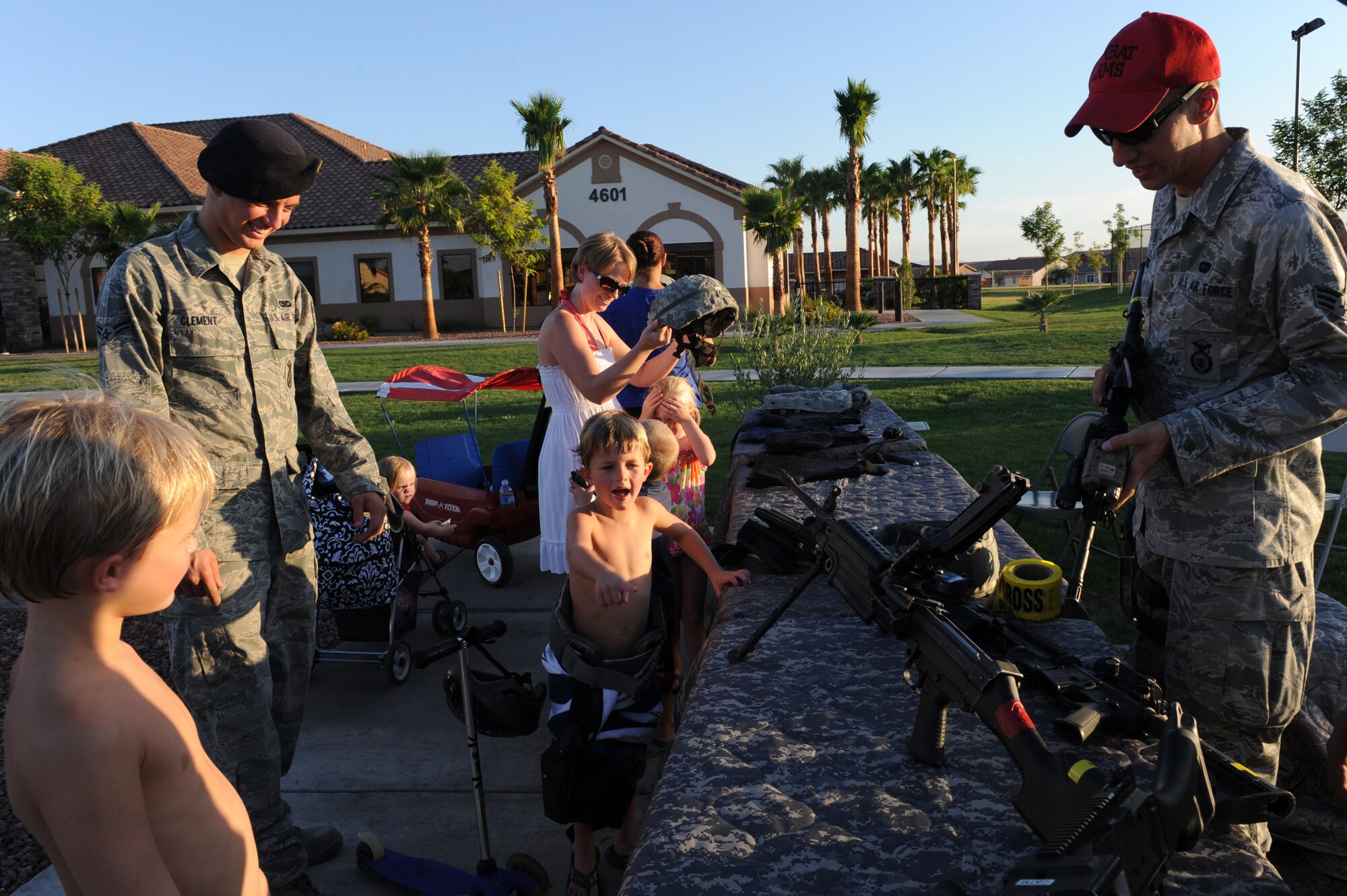 Members of the Nellis community try on protective equipment and view different weapons used by the 99th Security Forces Squadron during "National Night Out" August 8, 2012, at Nellis Air Force Base, Nev. "National Night Out" is a nationwide effort to heighten crime prevention awareness, generate support for local anti-crime programs and strengthen neighborhood spirit and police-community partnerships. (U.S. Air Force photo by Staff Sgt. William P.Coleman)
  

