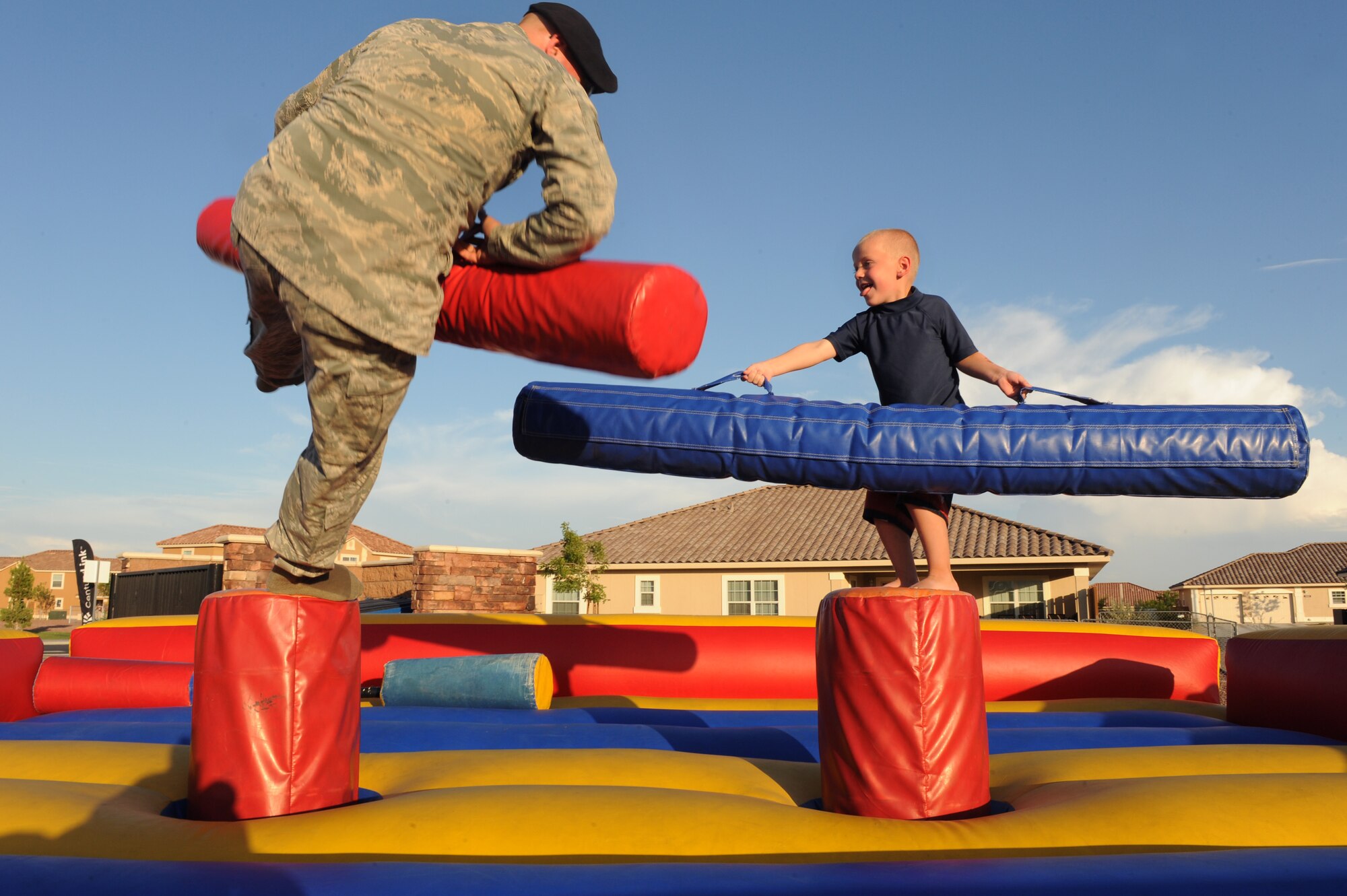 U.S. Air Force Staff Sgt. Jeffery Seamons, 99th Security Forces Squadron security forces craftsman, takes a hit from Zachary Stutzman, son of SrA Eric and Lindsay Stutzman, 823rd Aircraft Maintenance Squadron crew chief, during "National Night Out" August 8, 2012, at Nellis Air Force Base, Nev. "National Night Out" is a nationwide effort to heighten crime prevention awareness, generate support for local anti-crime programs and strengthen neighborhood spirit and police-community partnerships. (U.S. Air Force photo by Staff Sgt. William P.Coleman)
  


