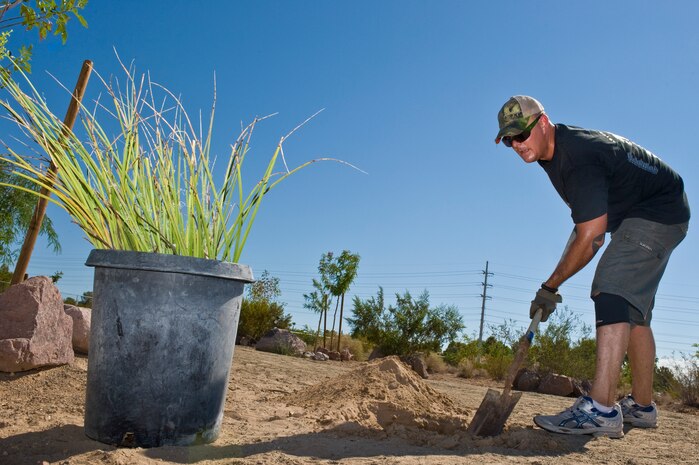 U.S. Air Force Tech.Sgt. David Havel, 422nd Aircraft Maintenance Squadron weapons expeditor, digs a hole during a volunteer tree planting at Veterans Memorial Park Aug. 2, 2012, in Boulder City, Nev. Volunteers planted trees, mulched, and set up emitters for the dog park section. (U.S. Air Force photo by Airman 1st Class Matthew Lancaster)