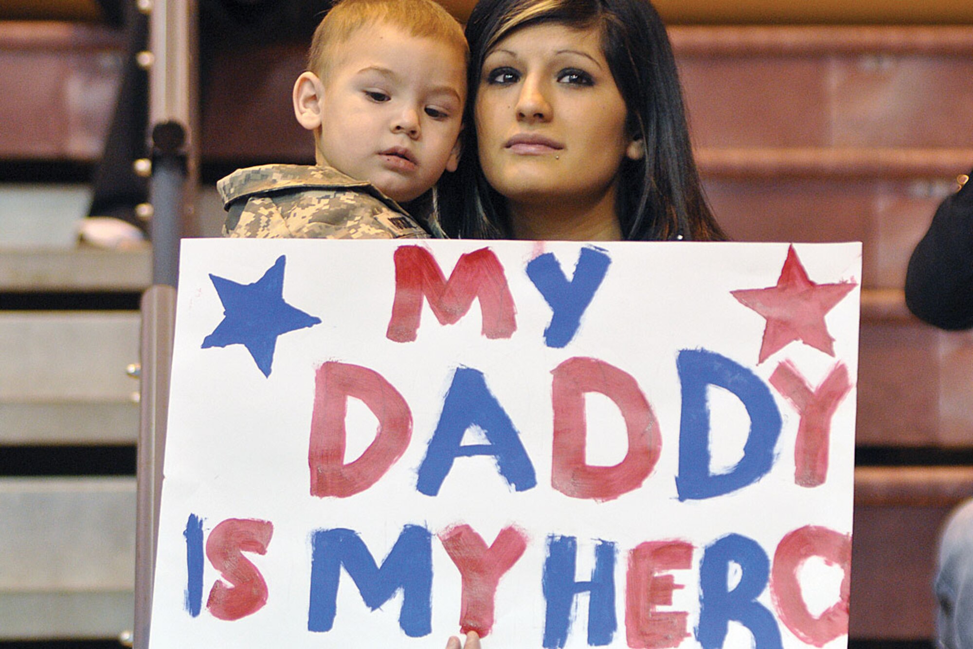 Chad Popchoke and his mother, Bianca, patiently await the arrival of Pfc. Christopher Popchoke, B Company, 3rd Battalion, 509th Parachute Infantry Regiment, at Buckner Physical Fitness Center March 1, 2010. (U.S. Army photo/John Pennell)