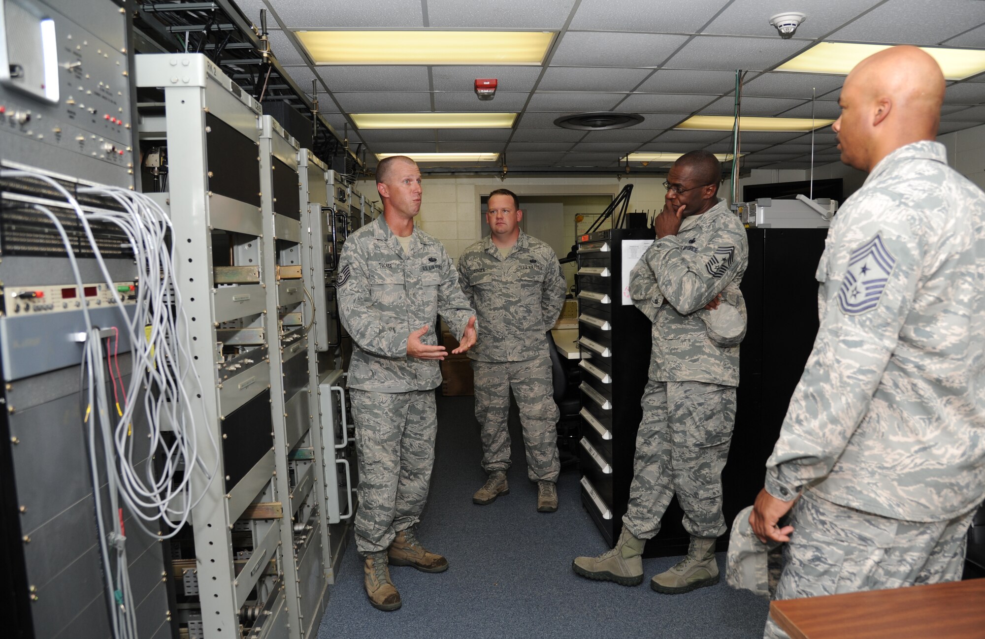 Tech. Sgts. Jason Tucker and Robert Conger, 85th Engineering Installation Squadron, gives a tour of the Ground to Air Transmit and Receive facility to Chief Master Sgts. Alfred Herring, 24th Air Force command chief, Lackland Air Force Base, Texas, and Linus Jordan, Air Force Space Command command chief, Peterson Air Force Base, Colo., August 9, 2012, at Keesler Air Force Base, Miss.  The two chiefs along with Chief Master Sgt. William Jones, 688th Information Operations Wing command chief, Lackland AFB, Texas, visited the 85th EIS for a one-day visit of its facilities and current projects and conducted enlisted calls.  (U.S. Air Force photo by Kemberly Groue)