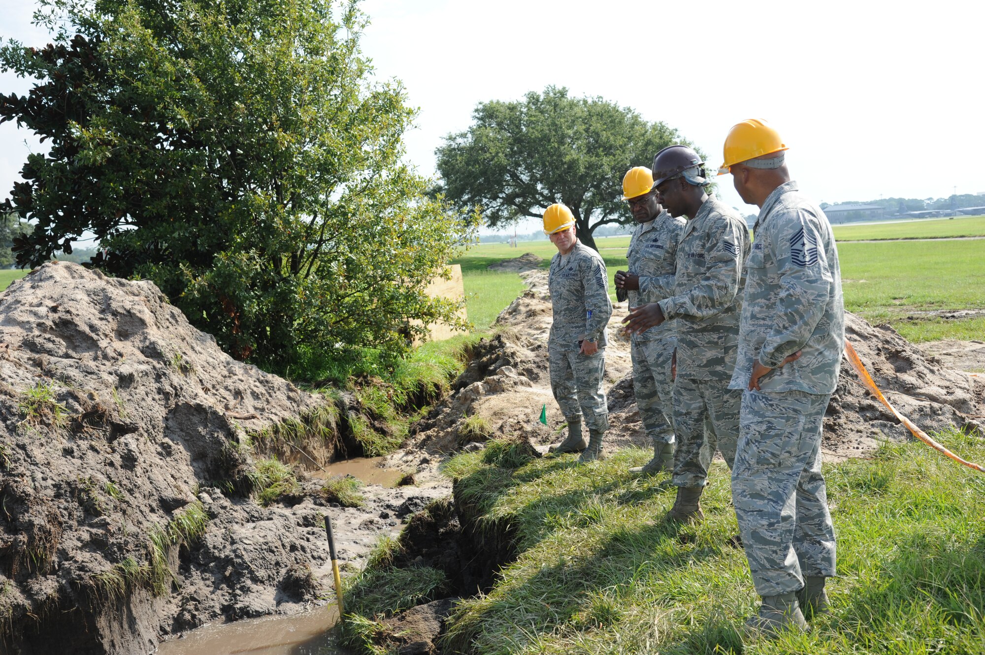 Staff Sgt. Joseph Perry, 85th Engineering Installation Squadron, in the brown hard hat, briefs Chief Master Sgts. William Jones, 688th Information Operations Wing command chief, Lackland Air Force Base, Texas;  Linus Jordan, Air Force Space Command command chief, Peterson Air Force Base, Colo.;  and Alfred Herring, 24th Air Force command chief, Lackland AFB, Texas, on the progress of a communications project August 9, 2012, at Keesler Air Force Base, Miss.  The chiefs visited the 85th EIS for a one-day visit of its facilities and current projects and conducted enlisted calls.  (U.S. Air Force photo by Kemberly Groue)