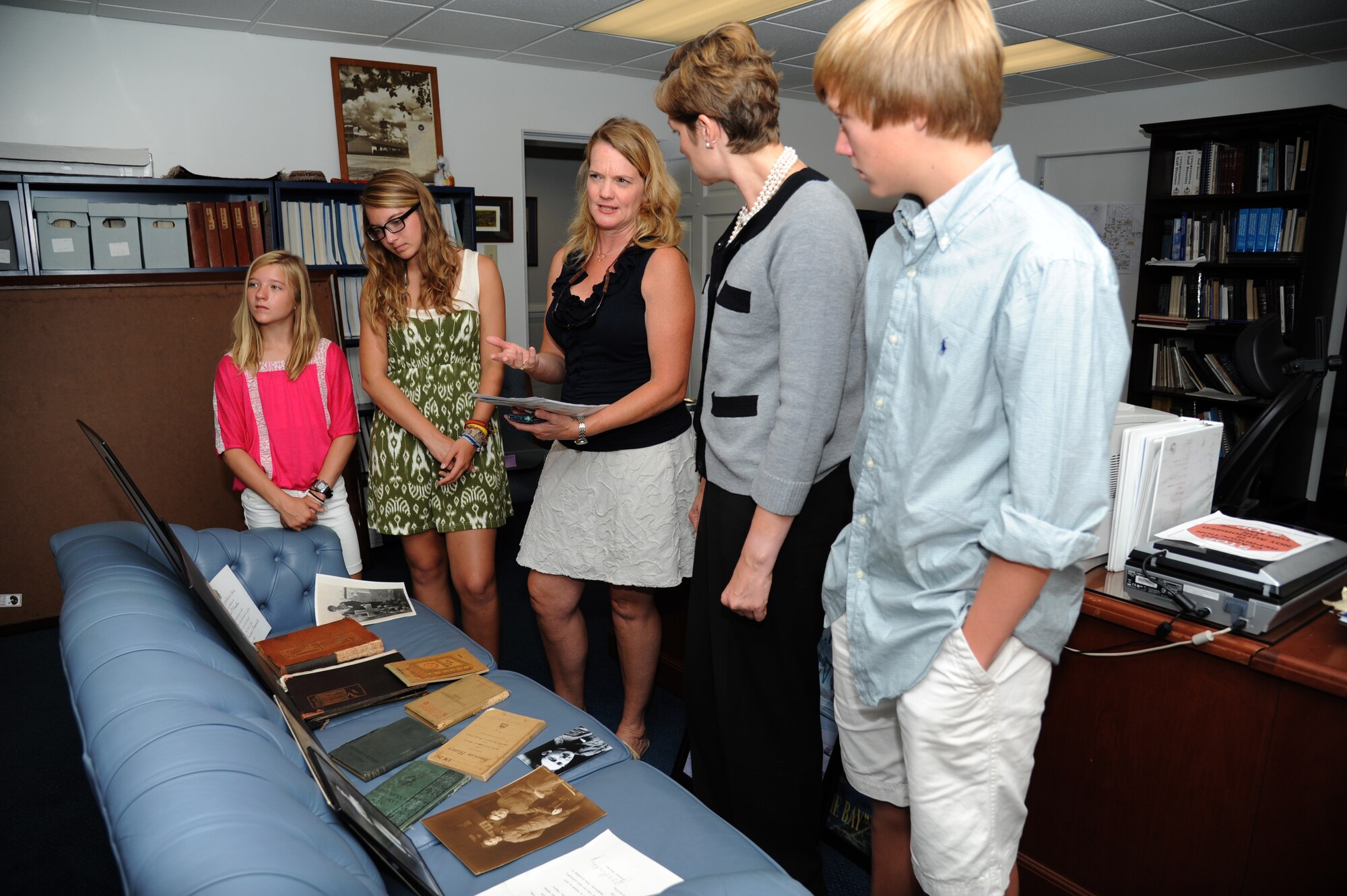 Tate Mueller, 11, along with her sister, Lee, 16, her mother, Sally, and Susan Dawson, 81st Training Wing base historian, and her brother, Cole, view various artifacts that belonged to 2nd Lt. Samuel Keesler and his family August 9, 2012, at the 81st Training Wing Headquarters, Keesler Air Force Base, Miss. Sally is the great-niece of Keesler.  (U.S. Air Force photo by Kemberly Groue)