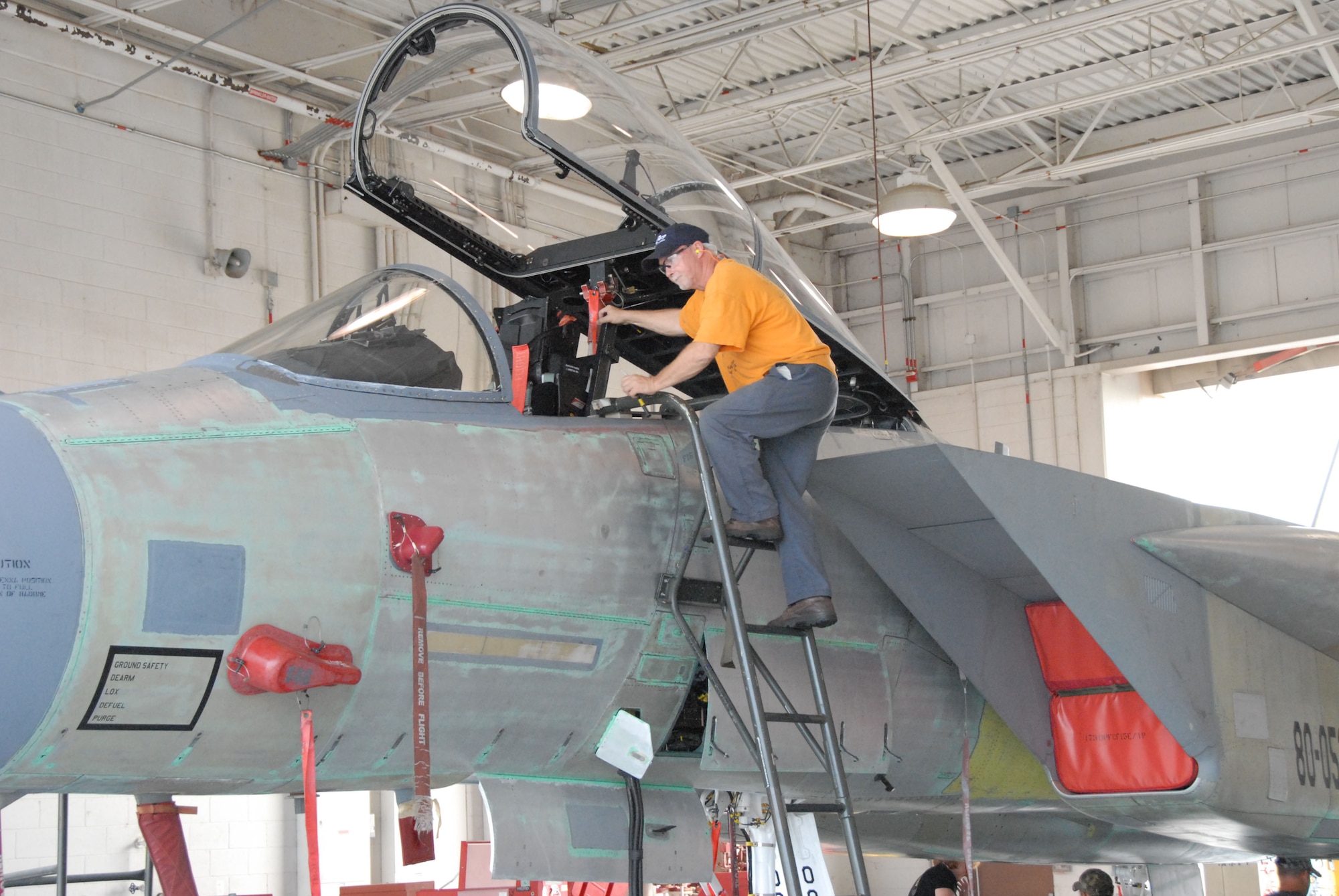 Mechanic Gregory Westberg enters the cockpit during the F-15 Functional Test. (U. S. Air Force photo/Misuzu Allen)
