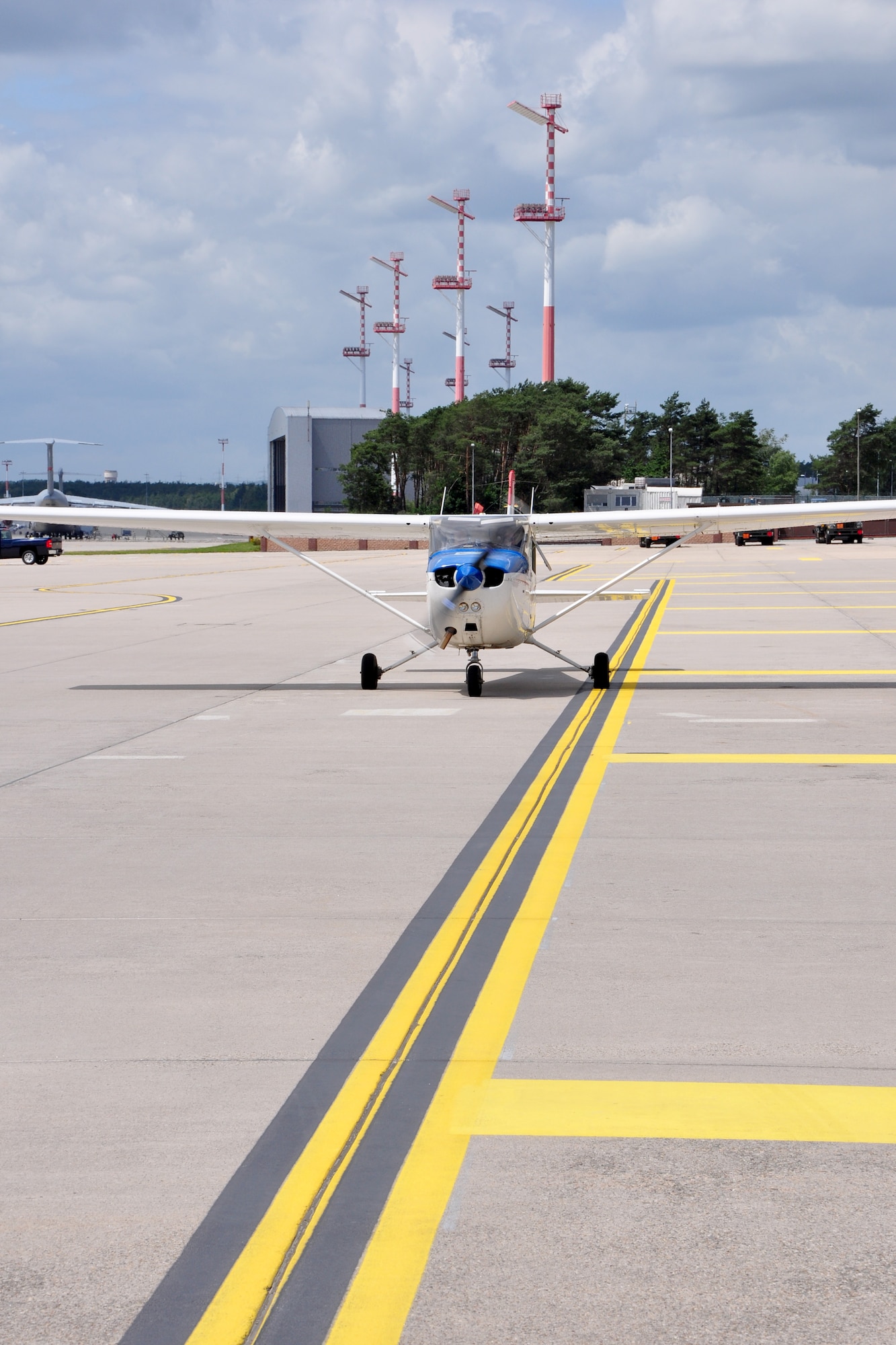 A Cessna 172 piloted by Lt. Col. Rich Radvanyi and co-piloted by Airman 1st Class Nicholas Fennen pulls away from the Ramstein Air Base, Germany, distinguished visitor lounge June 22, 2012. The flight was part of the Ramstein Daedalians Aviation Incentive Flight program, which provides quarterly aviation incentive flights to deserving young Airmen and gives them the chance to live a childhood fantasy of flight. (U.S. Air Force photo/Tech. Sgt. Chad Thompson)