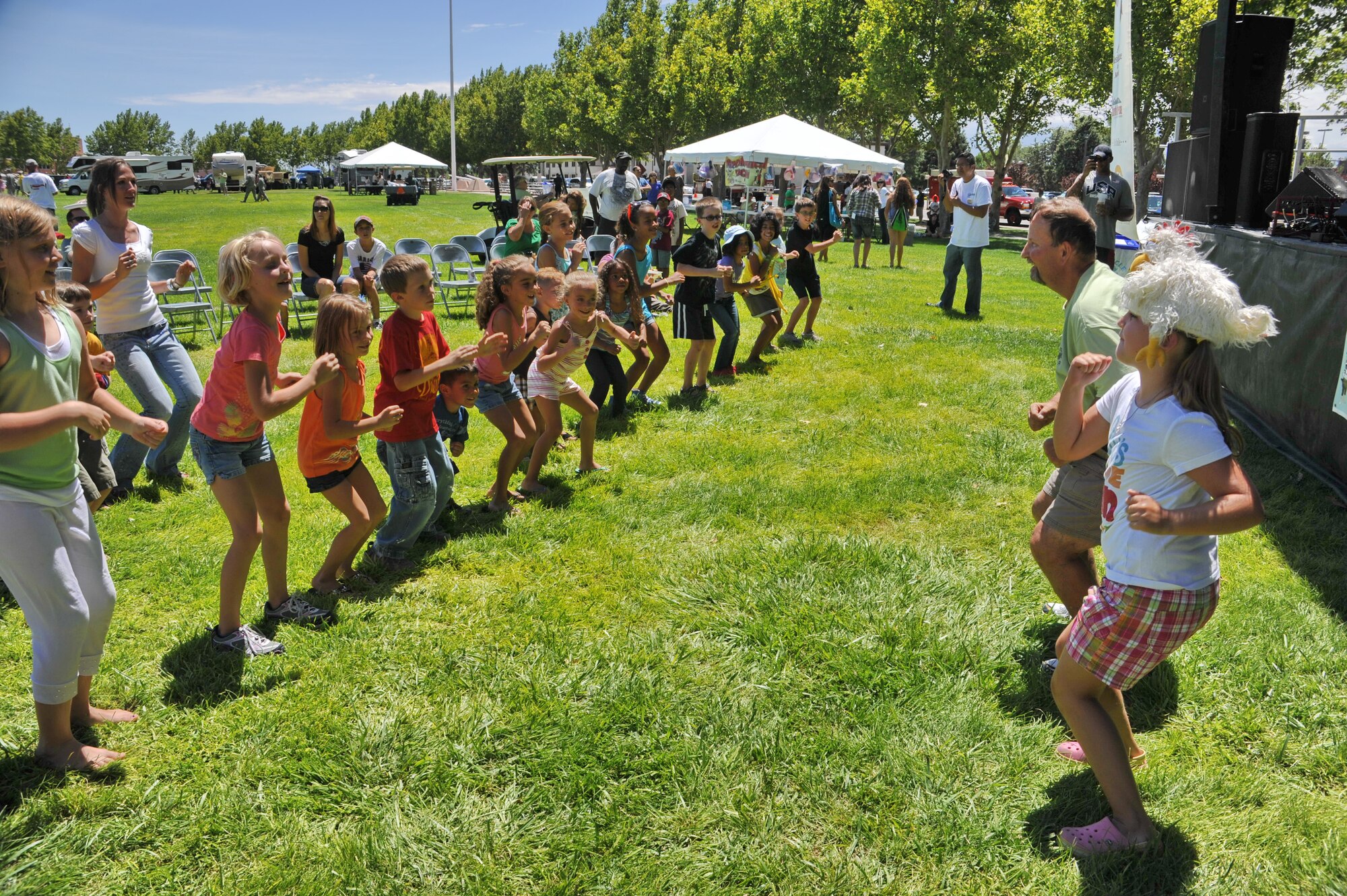 KIRTLAND AFB, N.M. – Thousands of people from Team Kirtland gathered Aug. 3 for Summer Bash at Hardin Field. The event had several activities, including a chicken dance contest for kids. (Photo by Ken Moore)