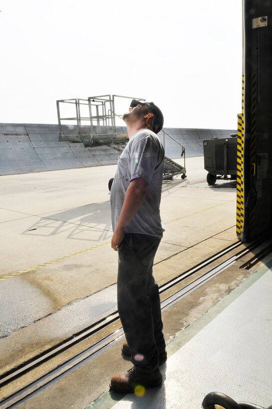 Derrick Schultz, aircraft mechanic, stands at the rear of a functional test bay to watch an F-15 launch for a test flight.  (U. S. Air Force photo/Sue Sapp)