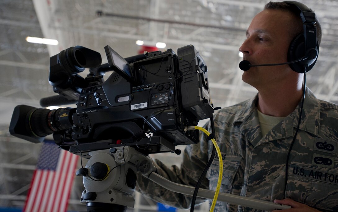 During a rehearsal in preparation for the Chief of Staff of the Air Force transition ceremony, Master Sgt. Robert Sims, Air Force TV broadcast journalist, checks the setting on his video camera at Joint Base Andrews, Md., on Aug. 9, 2012. Live coverage of the ceremony will begin at 10:30 a.m. (Eastern Daylight Time) on Aug. 10 via the Pentagon Channel. A simulcast of the ceremony can be found on the Pentagon Channel's web site: http://www.pentagonchannel.mil. A video feed of the ceremony will also be available on the Air Force's official web site at: http://www.af.mil/live.asp.Viewing on the Air Force Portal will be available through a log in splash screen. (U.S. Air Force Photo/Senior Airman Perry Aston)