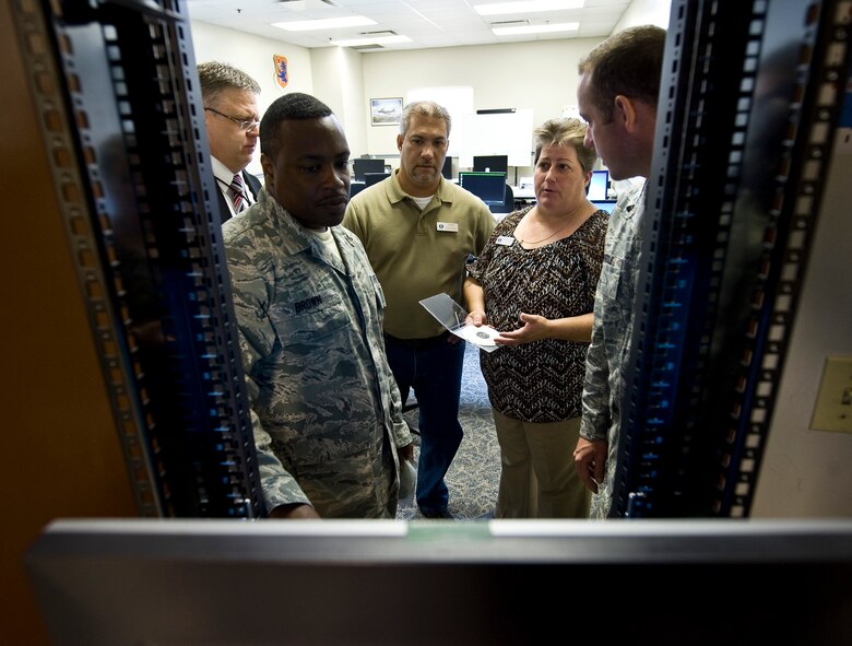 Air Force Engineering and Technical Service employees train active duty members on how to program a computer based scenario simulator on Barksdale Air Force Base, La., Aug. 9. AFETS are civilian employees, mostly prior military, who mentor and assist active duty maintenance and communications Airmen here and while deployed. (U.S. Air Force photo/Staff Sgt. Chad Warren)(RELEASED)