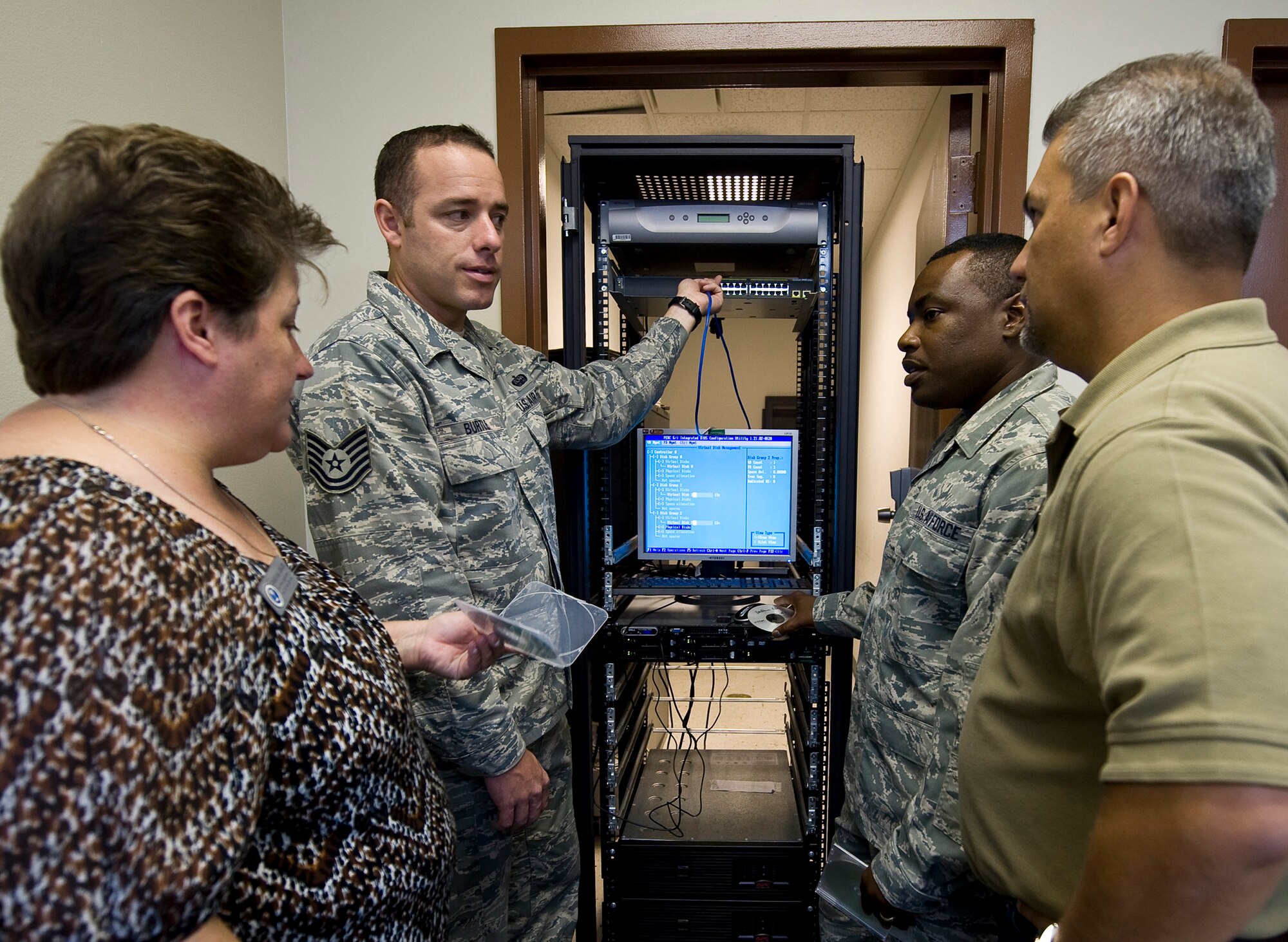 Air Force Engineering and Technical Service employees train active duty members on how to program a computer based scenario simulator on Barksdale Air Force Base, La., Aug. 9. AFETS recruits mostly prior military members to remain as part of the force and work alongside active duty maintenance and communications Airmen. (U.S. Air Force photo/Staff Sgt. Chad Warren)(RELEASED)