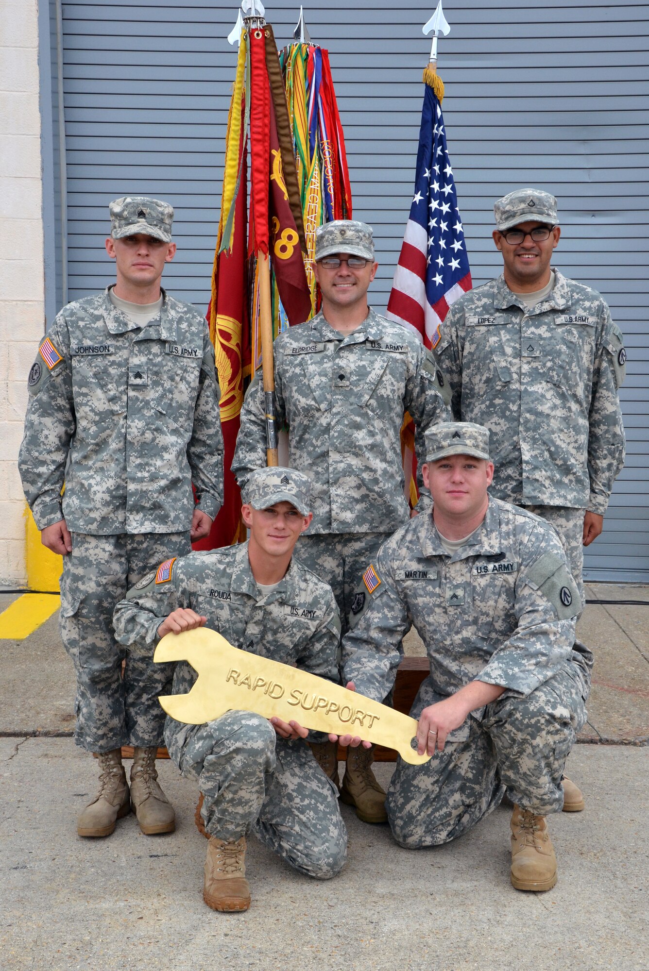(Clockwise from top left) 688th Rapid Port Opening Element Soldiers, Sgt. Devin Johnson, a shop foreman, Spc. Reuben Eldridge, tool-room clerk; Pfc. Bryan Lopez, Standard Army Maintenance System clerk, Cpl. Joshua Martin, shop office non-commissioned officer in charge, and Sgt. Jeffrey Rouda, motor sergeant, display the "Golden Wrench" award at Fort Eustis, Va., Aug. 6, 2012. The 688th RPOE won the award for their achievement as the 597th Transportation Brigade's best maintenance program for third-quarter 2012. (U.S. Army photo by Michelle Montieth/Released)