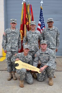 (Clockwise from top left) 688th Rapid Port Opening Element Soldiers, Sgt. Devin Johnson, a shop foreman, Spc. Reuben Eldridge, tool-room clerk; Pfc. Bryan Lopez, Standard Army Maintenance System clerk, Cpl. Joshua Martin, shop office non-commissioned officer in charge, and Sgt. Jeffrey Rouda, motor sergeant, display the "Golden Wrench" award at Fort Eustis, Va., Aug. 6, 2012. The 688th RPOE won the award for their achievement as the 597th Transportation Brigade's best maintenance program for third-quarter 2012. (U.S. Army photo by Michelle Montieth/Released)