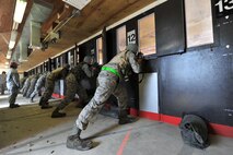 MINOT AIR FORCE BASE, N.D. -- Airmen participating in combat arms training and maintenance, fire their weapons here, Aug. 2. The basic marksman skill training includes intensive weapons training and incorporates target acquisition, threat discrimination, multiple-threat engagement and surviving weapon malfunction and stoppages.  (U.S. Air Force photo/Senior Airman Brittany Y. Auld)