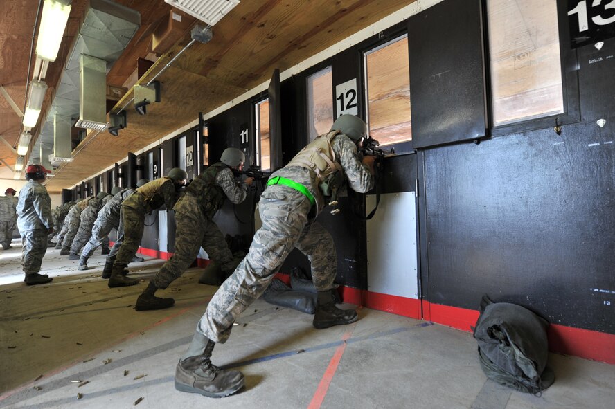 MINOT AIR FORCE BASE, N.D. -- Airmen participating in combat arms training and maintenance, fire their weapons here, Aug. 2. The basic marksman skill training includes intensive weapons training and incorporates target acquisition, threat discrimination, multiple-threat engagement and surviving weapon malfunction and stoppages.  (U.S. Air Force photo/Senior Airman Brittany Y. Auld)