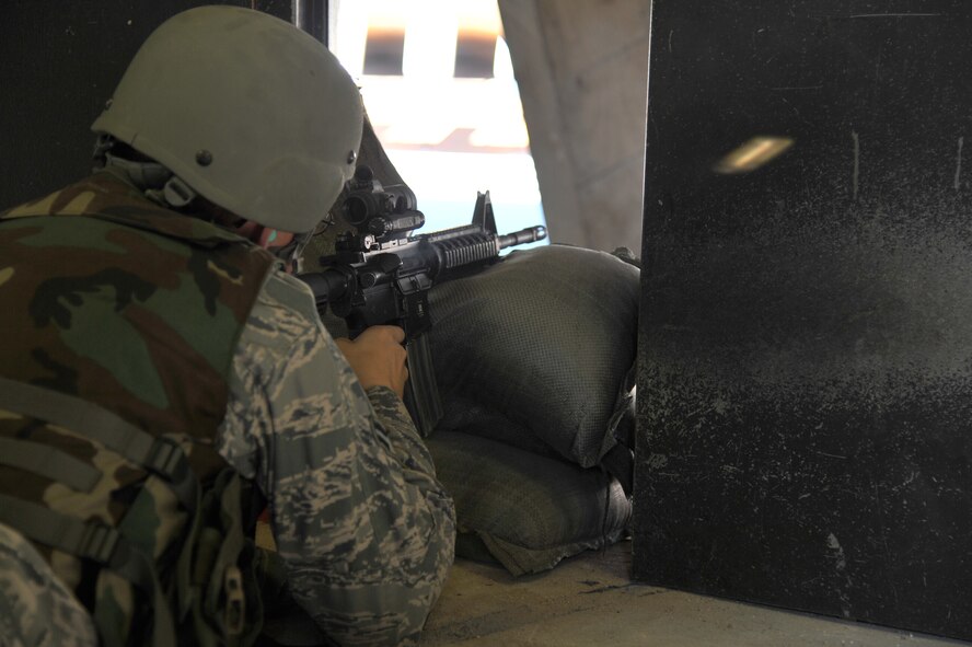 MINOT AIR FORCE BASE, N.D. – Airman 1st Class Dylan Siegle, 5th Maintenance Squadron, fires his weapon during combat arms training and maintenance here, Aug. 2.  Combat arms training and maintenance instructors are security forces personnel who train military members on weapon use. (U.S. Air Force photo/Senior Airman Brittany Y. Auld)