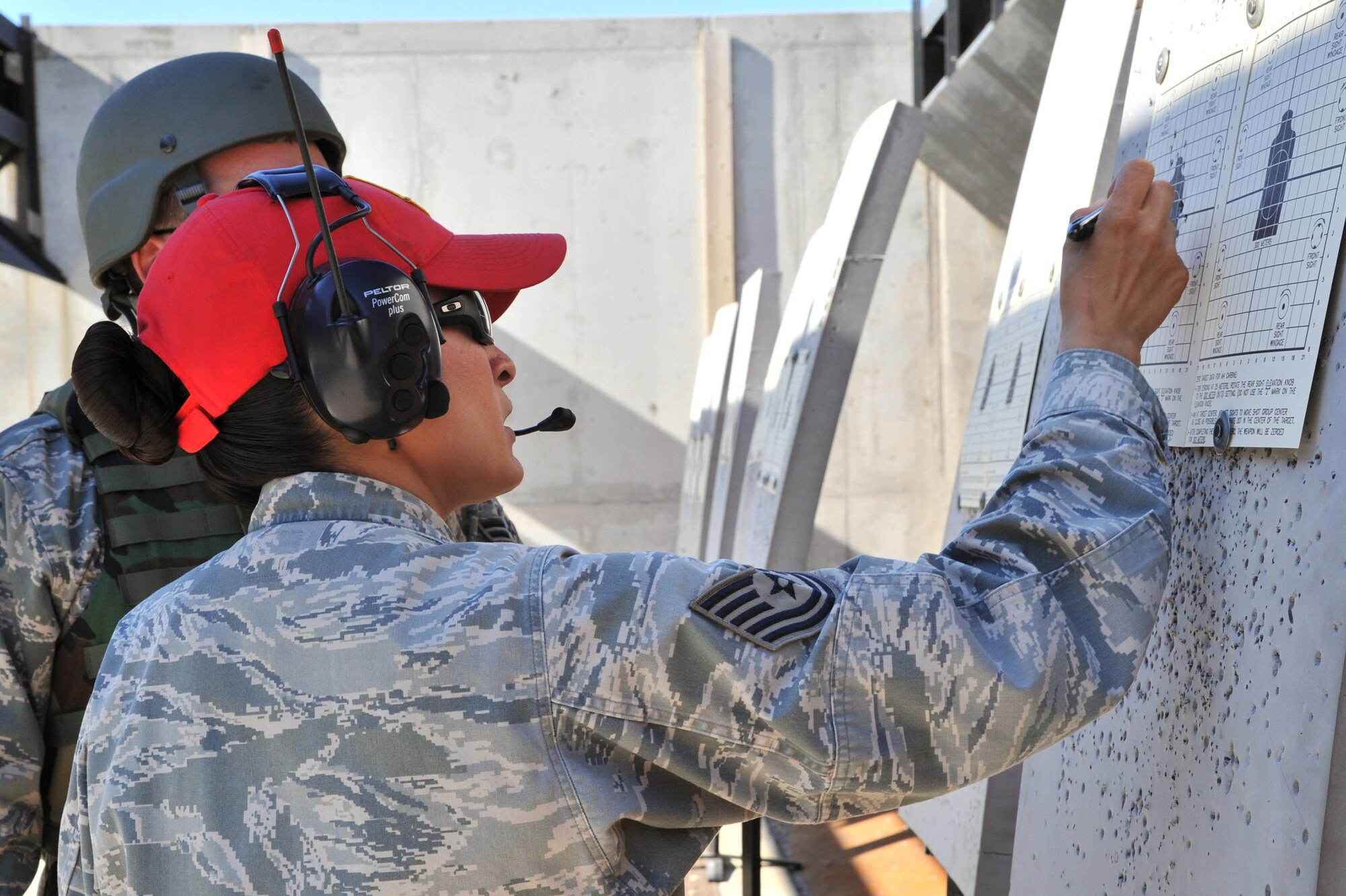 MINOT AIR FORCE BASE, N.D. – Tech. Sgt. Yvonne Groves, 5th Security Forces Squadron combat arms and maintenance non-commissioned officer in-charge, marks a target for sight corrections during training here, Aug. 2. The basic marksman skill training includes intensive weapons training and incorporates target acquisition, threat discrimination, multiple-threat engagement and surviving weapon malfunction and stoppages. (U.S. Air Force photo/Senior Airman Brittany Y. Auld)