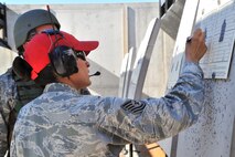 MINOT AIR FORCE BASE, N.D. – Tech. Sgt. Yvonne Groves, 5th Security Forces Squadron combat arms and maintenance non-commissioned officer in-charge, marks a target for sight corrections during training here, Aug. 2. The basic marksman skill training includes intensive weapons training and incorporates target acquisition, threat discrimination, multiple-threat engagement and surviving weapon malfunction and stoppages. (U.S. Air Force photo/Senior Airman Brittany Y. Auld)