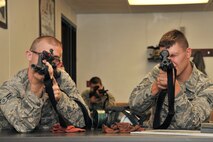 MINOT AIR FORCE BASE, N.D. – Airmen practice holding their weapons properly during combat arms training and maintenance here, Aug. 1.  The basic marksman skill training includes intensive weapons training, and incorporates target acquisition, threat discrimination, multiple-threat engagement and surviving weapon malfunction and stoppages. (U.S. Air Force photo/Senior Airman Brittany Y. Auld)