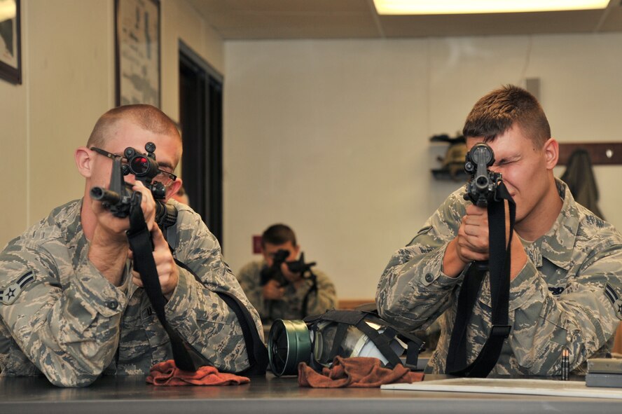 MINOT AIR FORCE BASE, N.D. – Airmen practice holding their weapons properly during combat arms training and maintenance here, Aug. 1.  The basic marksman skill training includes intensive weapons training, and incorporates target acquisition, threat discrimination, multiple-threat engagement and surviving weapon malfunction and stoppages. (U.S. Air Force photo/Senior Airman Brittany Y. Auld)