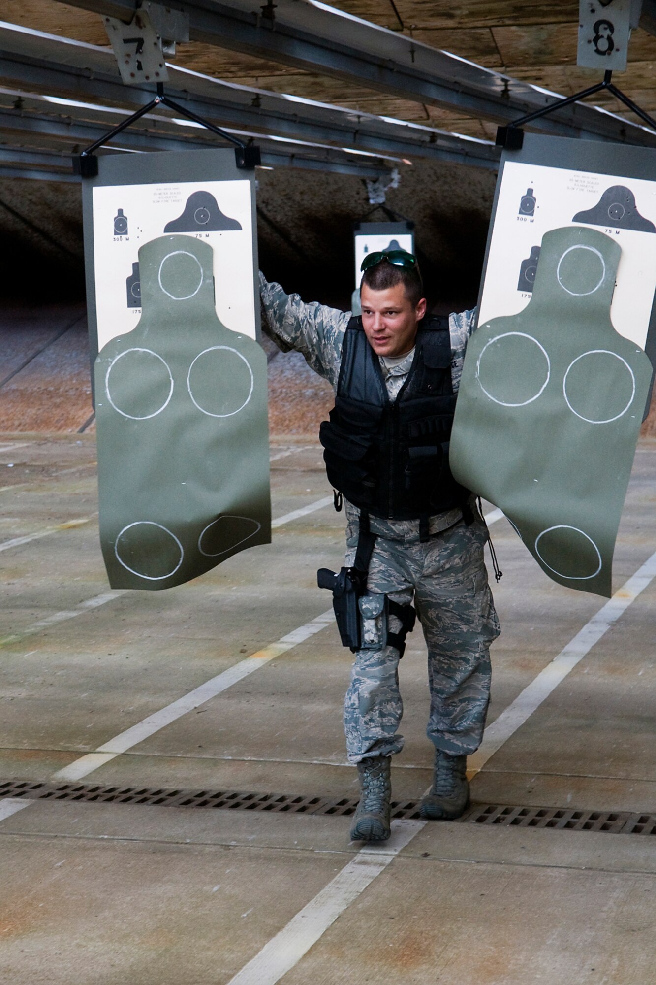 GRISSOM AIR RESERVE BASE, Ind. -- Senior Airman Mark Houlihan, 434th Security  Forces Squadron fire team member, moves his targets into position during a recent weapons training event held here June 2. During the training, Houlihan and other 434th SFS Airmen each fired off 276 rounds from M-4 rifles, 100 rounds from M-9 pistols and multiple rounds from M-203 grenade launchers. (U.S. Air Force Photo/Jami K. Lancette)
