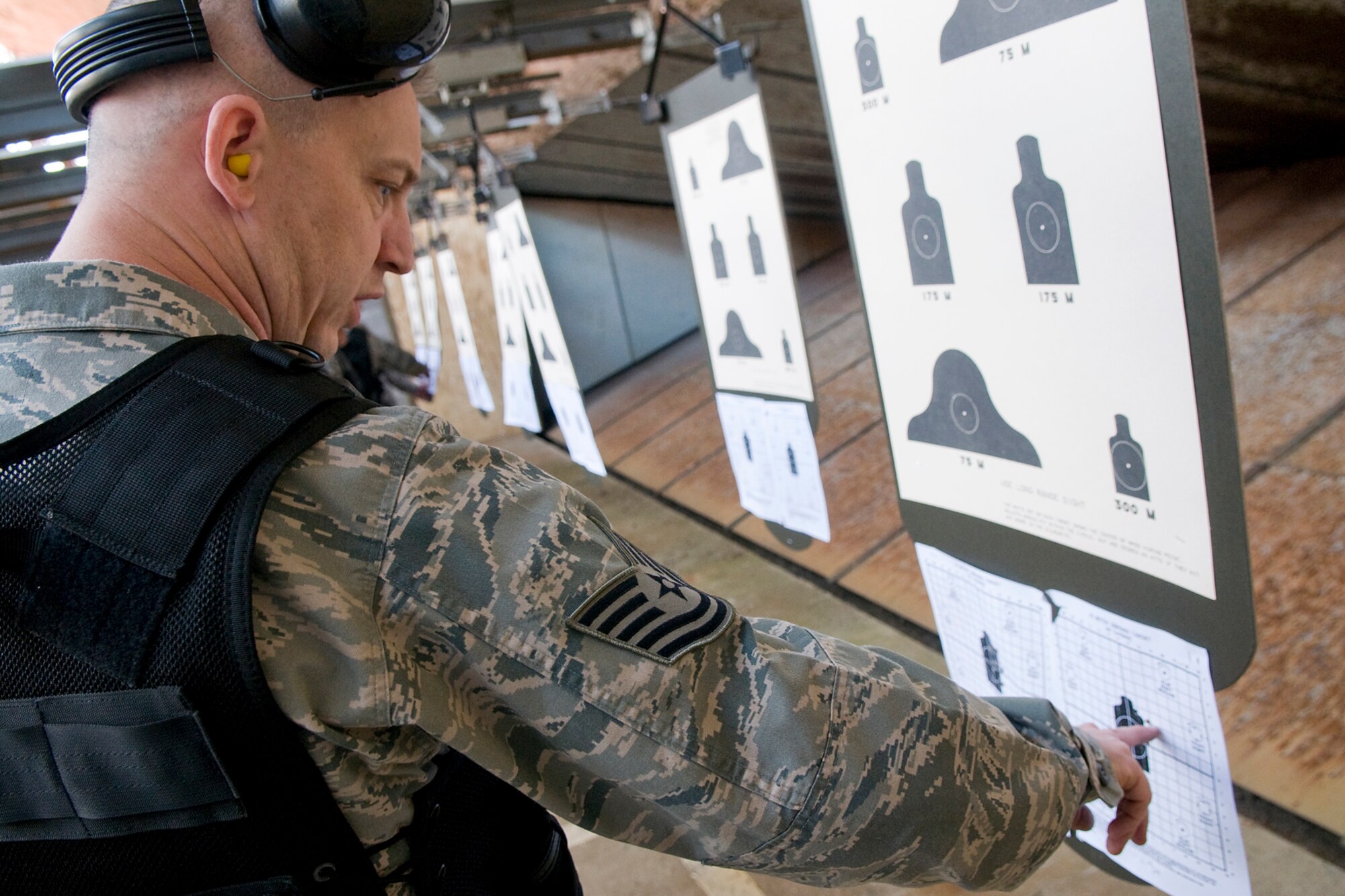 GRISSOM AIR RESERVE BASE, Ind. -- Tech. Sgt. Jarred Gentile, 434th Security Forces Squadron fire team leader,  checks the placement of his shots during a recent weapons training held here. Gentile and his fellow 434th SFS Airmen shot through the day and qualified at night using night vision equipment. (U.S. Air Force Photo/Jami K. Lancette)
