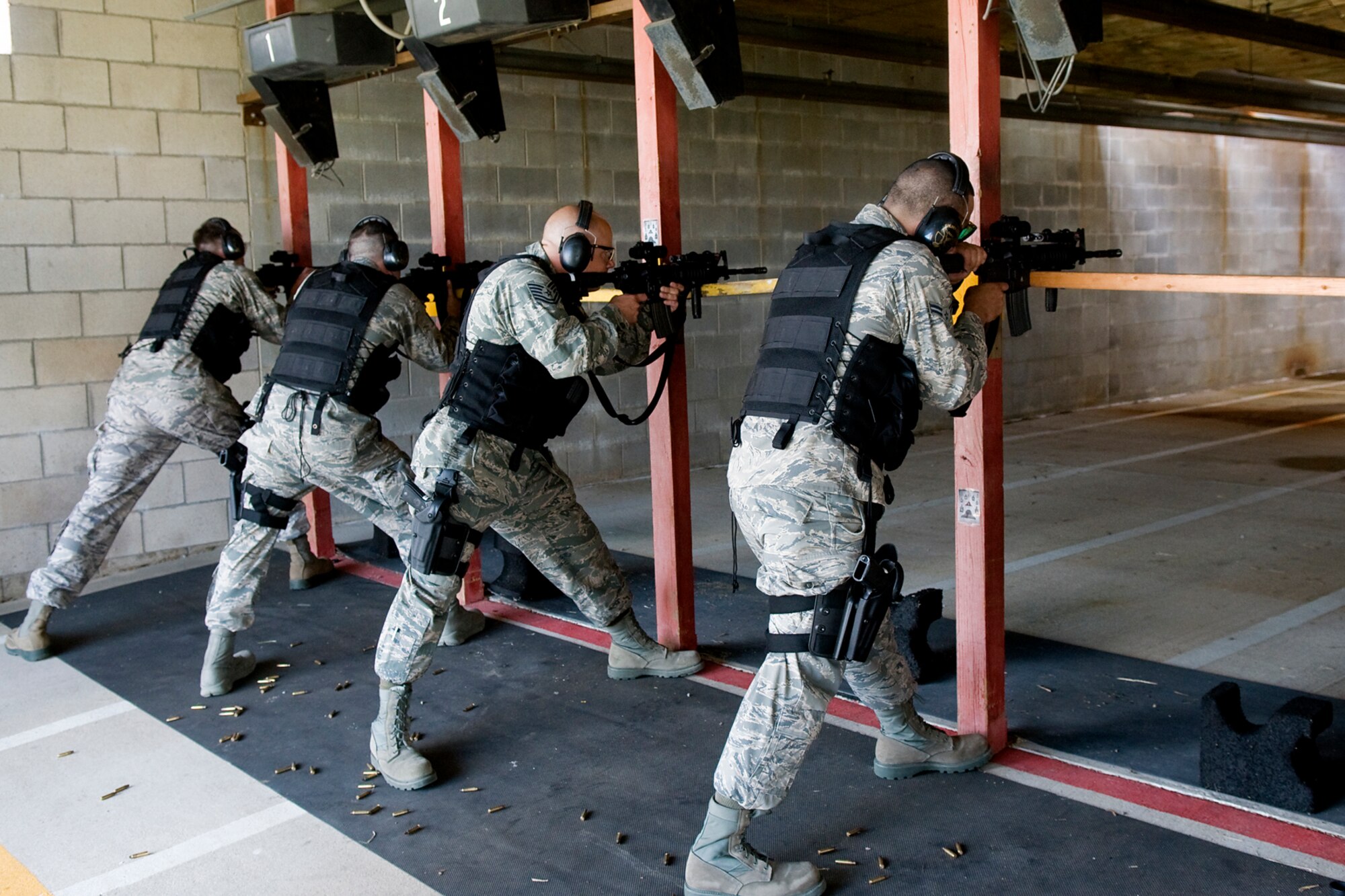 GRISSOM AIR RESERVE BASE, Ind. -- 434th Security Forces Squadron Airmen fire their M-4 carbine rifles during a recent weapons training event held here. Each Airman fired off approximately 276 rounds from M-4 rifles, 100 rounds from M-9 pistols and multiple rounds from M-203 grenade launchers.  (U.S. Air Force Photo/Jami K. Lancette)
