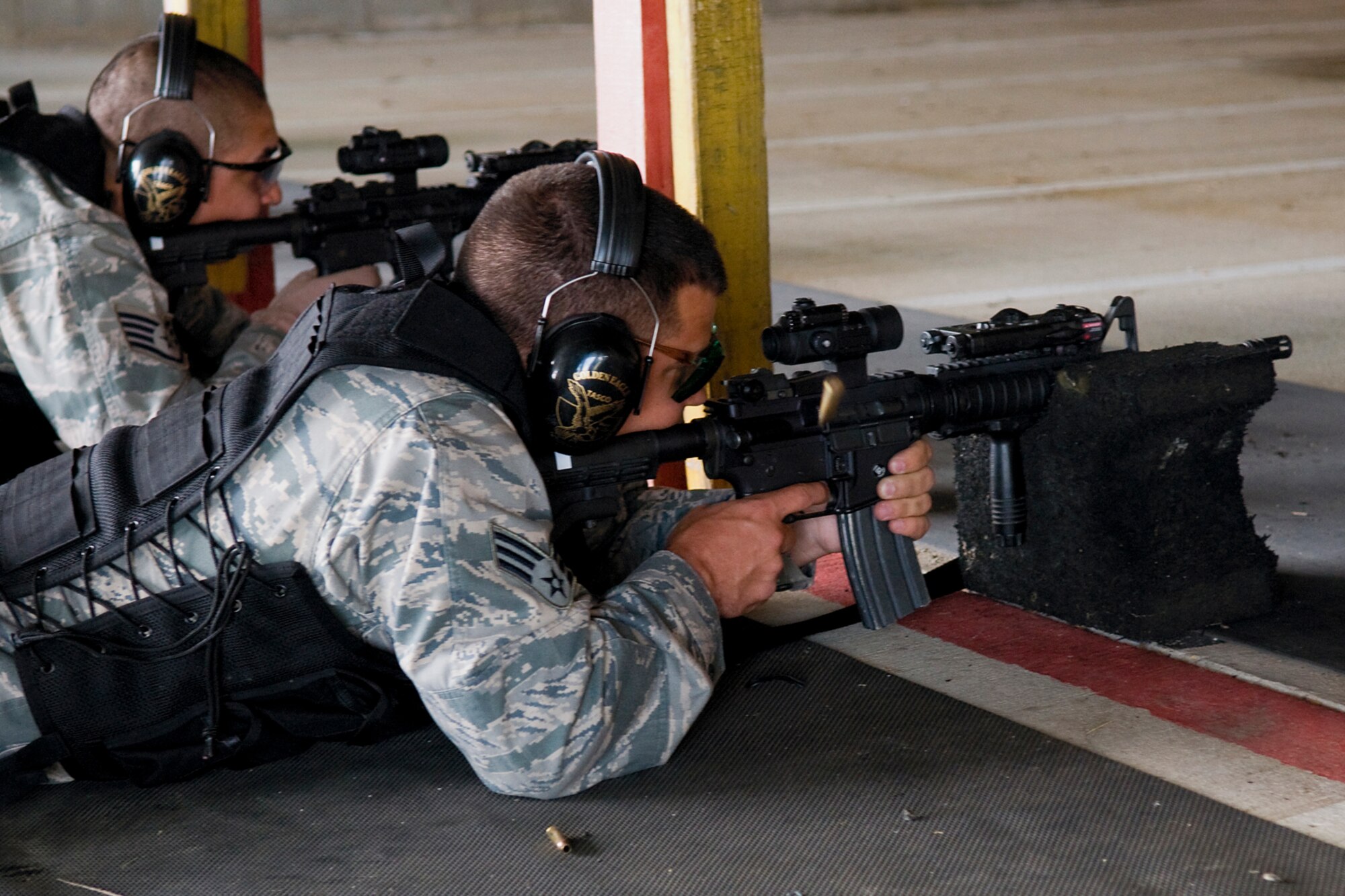 GRISSOM AIR RESERVE BASE, Ind. -- 434th Security Forces Squadron Airmen fire their M-4 carbine rifles during a recent weapons training event held here. Each Airman fired off approximately 276 rounds from M-4 rifles, 100 rounds from M-9 pistols and multiple rounds from M-203 grenade launchers.  (U.S. Air Force Photo/Jami K. Lancette)
