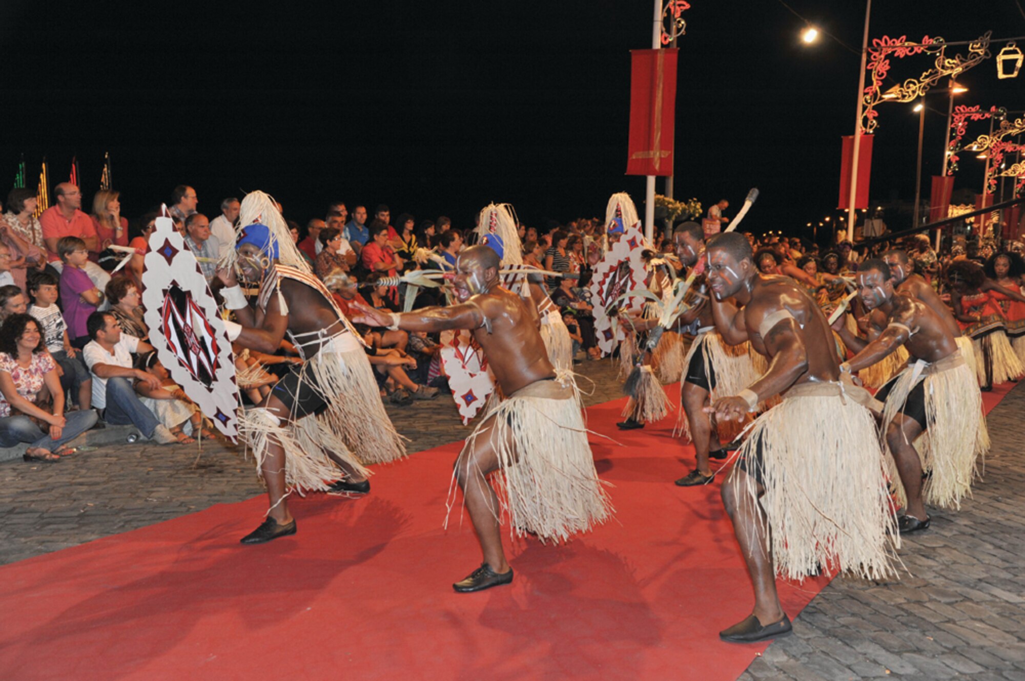 Members of Lajes' African American Heritage Committee played the roles of African hunters and warriors during the Praia Fest opening parade Aug. 4. The parade traced the roots of "Carnival" and showed the people of Terceira how celebrations began in the villages of Africa and then progressed through the years into festivals and carnival parades. This was the first time in history U.S. members of Lajes Field were invited to join the Portuguese community in Praia Fest by participating in their opening parade. (Photo by Guido Melo)