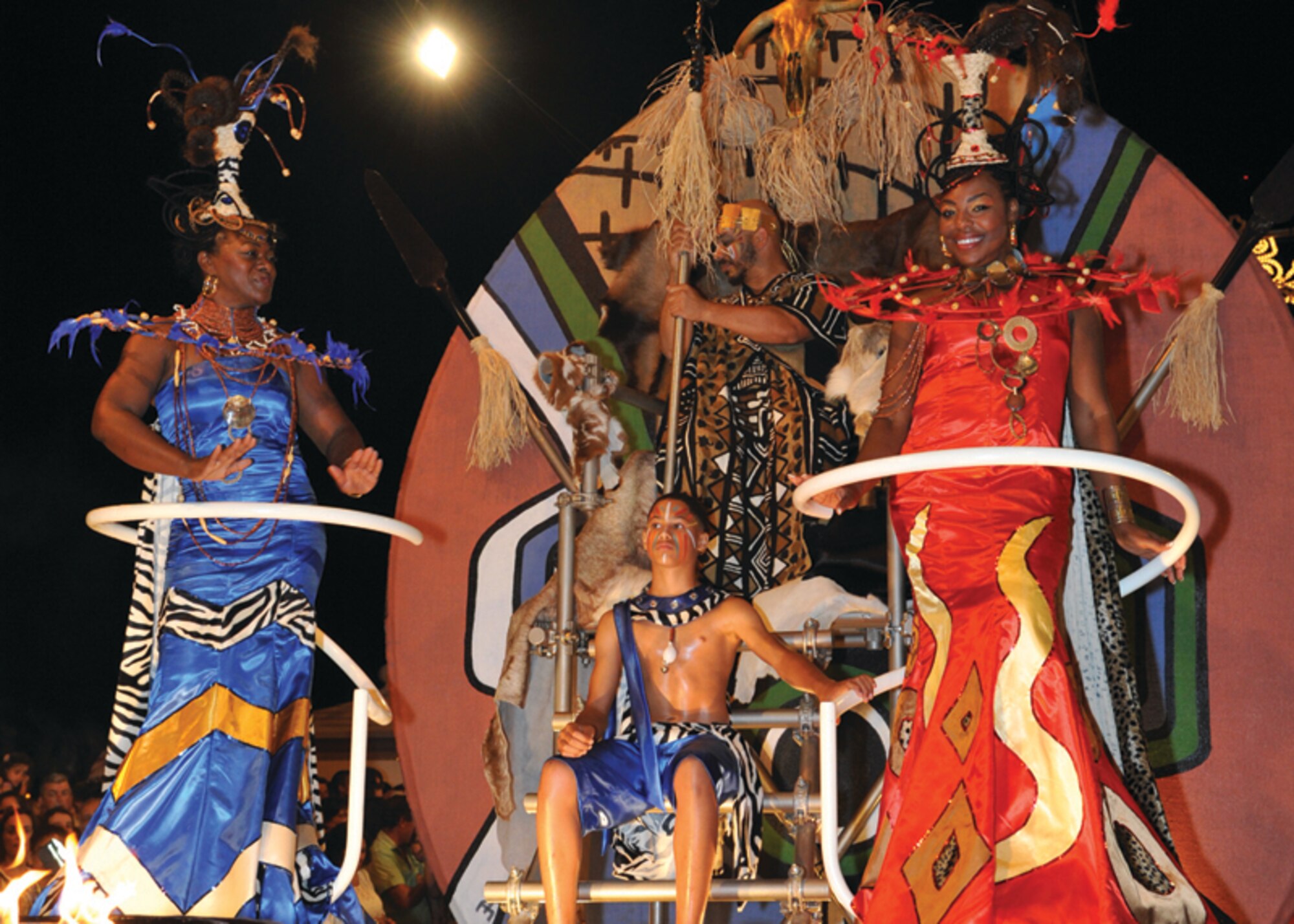 An African king, prince and two queens greet thousands of people in Praia da Vitoria during the Praia Fest opening parade Aug. 4. Greg “Goldie” Williams, husband of Master Sgt. Scarlet Williams, 65th Civil Engineer Squadron, played the African king. The elder queen, retired Chief Master Sgt. Cynthia Burney, 65th Force Support Squadron, and the younger queen, Shemekia McMillan, wife of Staff Sgt. Joseph McMillan, 65th Communications Squadron, waved and blew kisses to thousands of people standing along the red carpet. These were members of Lajes' African American Heritage Committee.  (Photo by Guido Melo)