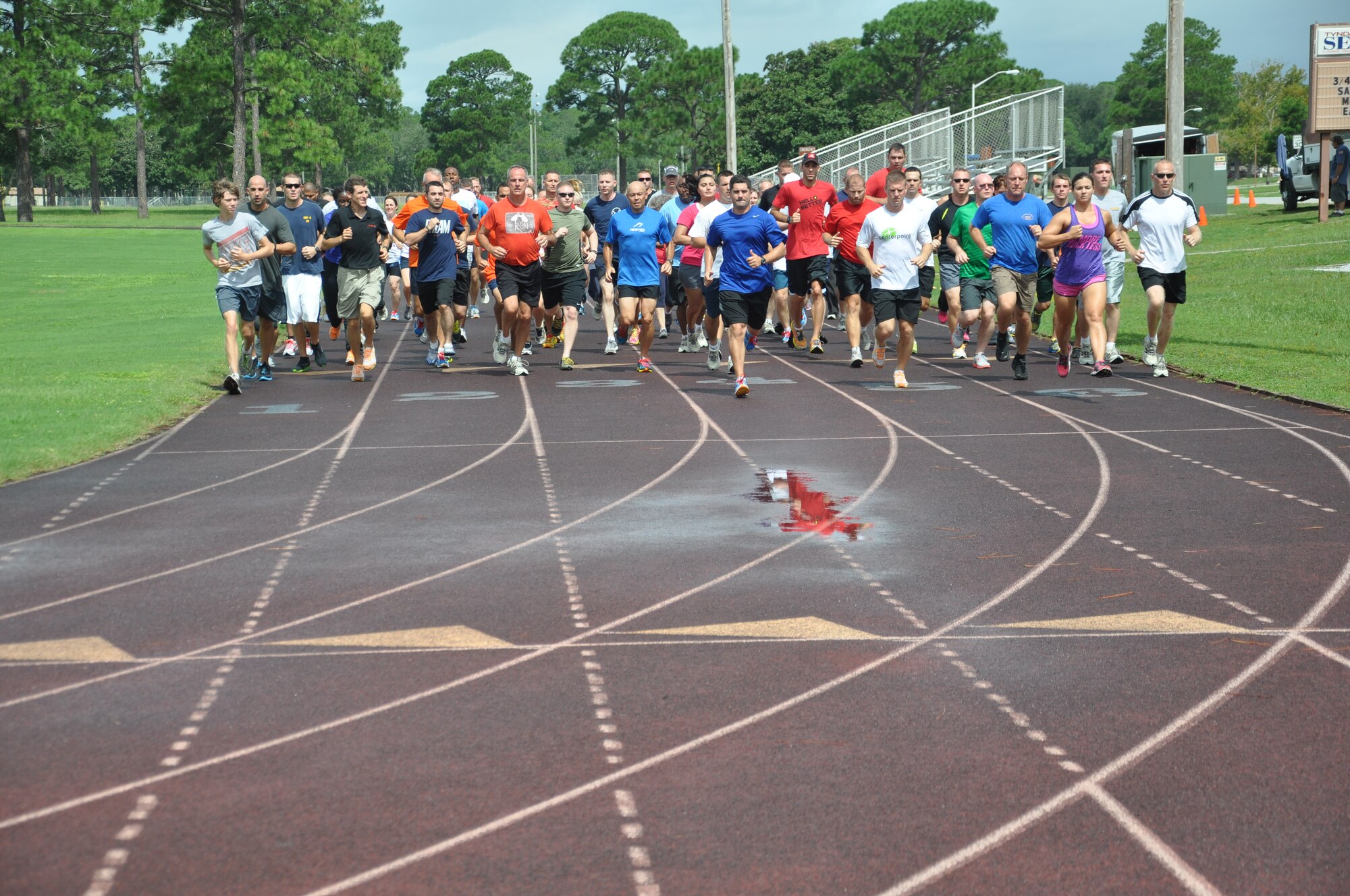 Nearly 100 Team Tyndall members particpate in a running drill as part of a  two-day Newton running clinic. (U.S. Air Force photo by Staff Sergeant Rachelle Elsea)