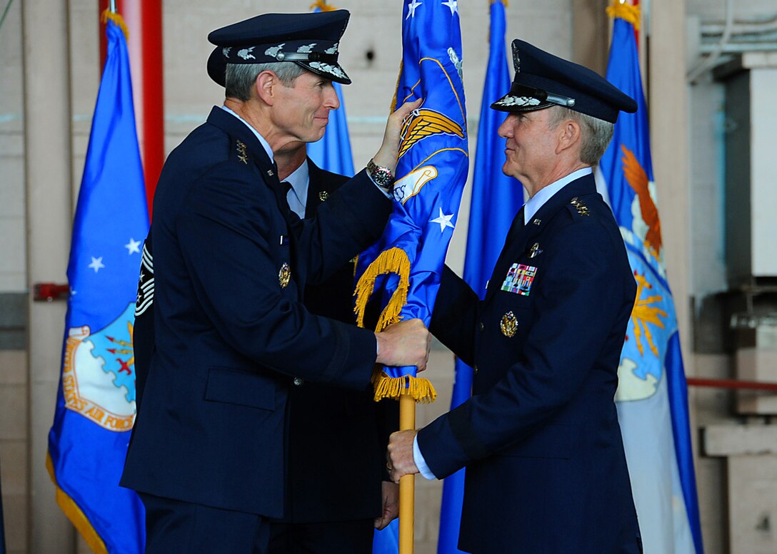 Air Force Chief of Staff Gen. Norton Schwartz presents the Pacific Air Forces flag to new PACAF commander Gen. Herbert Carlisle, signifying the transfer of command at Joint Base Pearl Harbor-Hickam, Hawaii, Aug. 3, 2012. Carlisle is the successor to Gen. Gary North, who is set to retire Oct. 1. (U.S. Air Force photo/Tech. Sgt. Jerome S. Tayborn) 