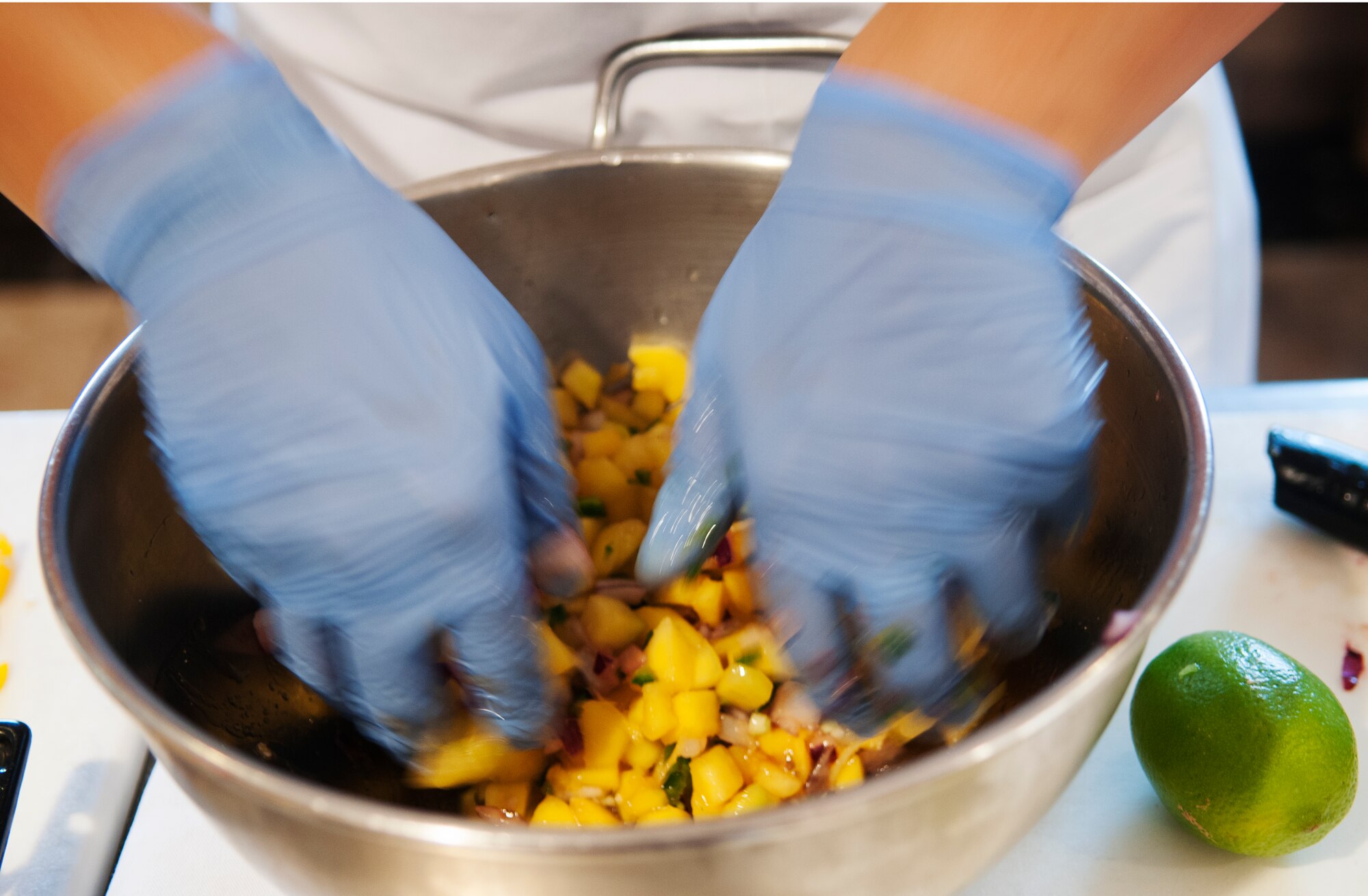Fruits and vegetables are being mixed to make salsa for the main course during the  quarterly Aviano Top Chef Competition at the La Dolce Vita dining facility August 6 at Aviano Air Base, Italy. The Company Grade Officer’s Council, Top 3 and Aviano Airmen Advisory Council were each represented by three members who competed to concoct a meal and dessert in one hour. (U.S. Air Force photo/Airman 1st Class Briana Jones)

